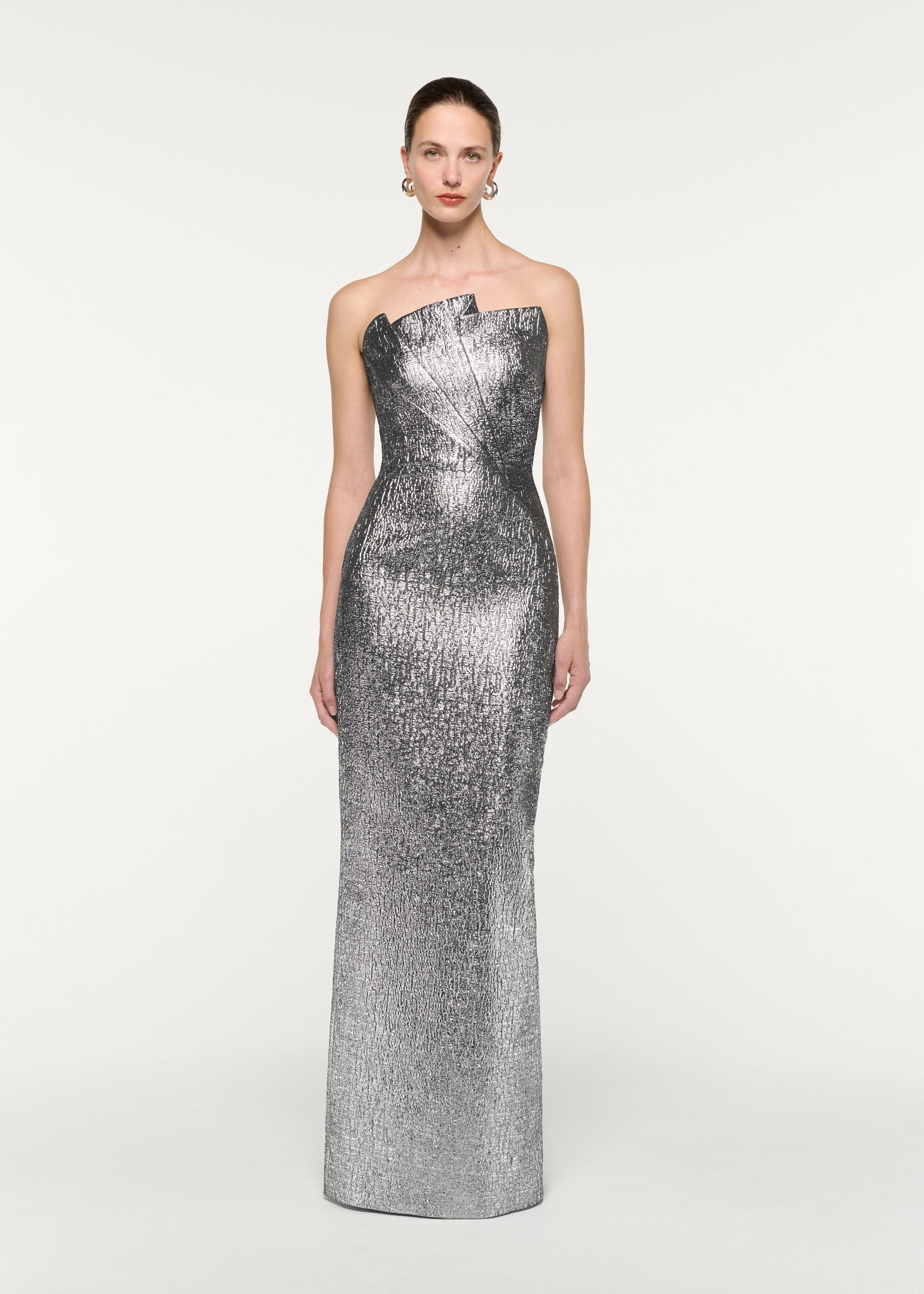 Front view of a model wearing the Pleated Strapless Metallic Jacquard Gown