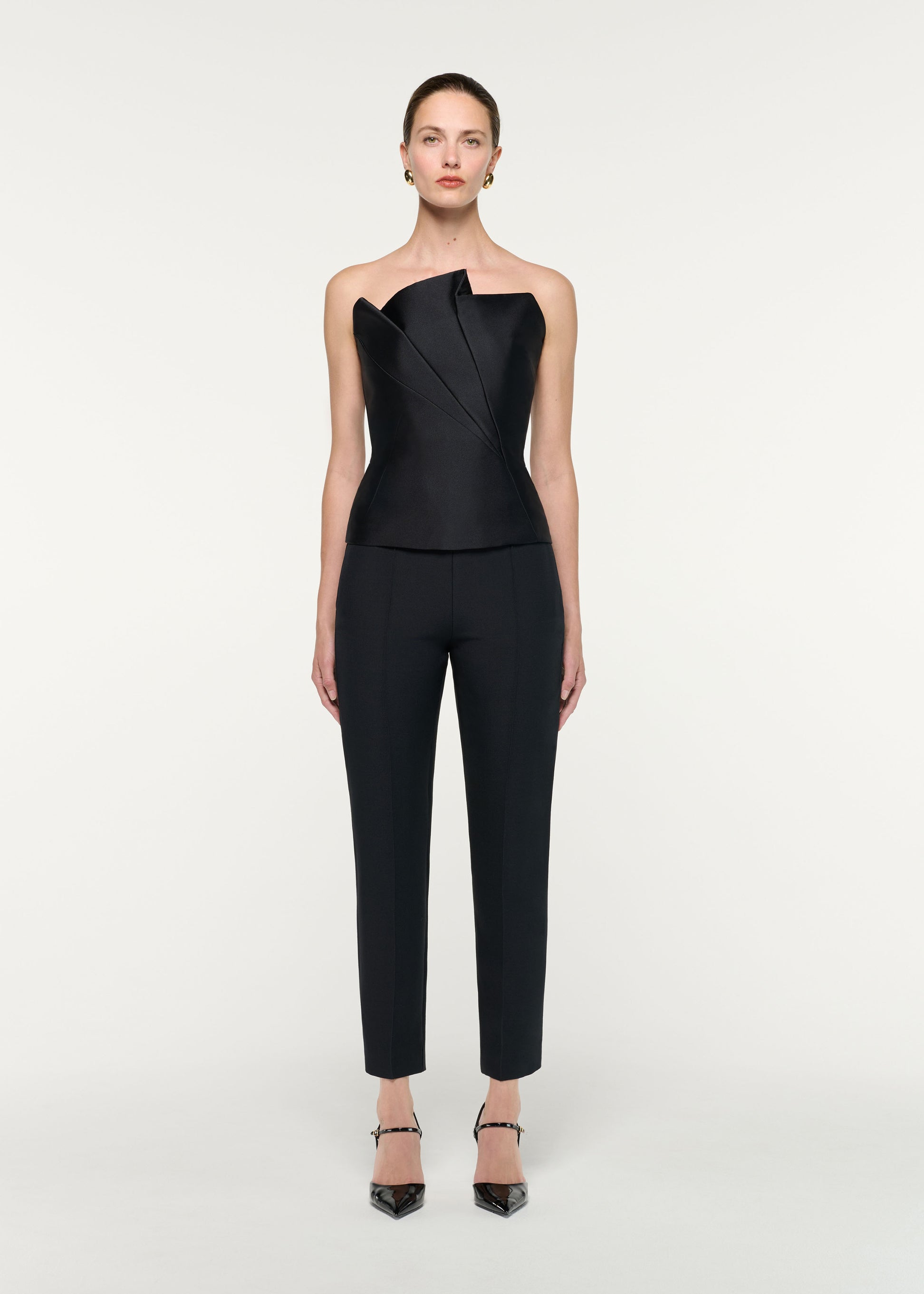 Front view of a model wearing the Pleated Strapless Taffeta Top