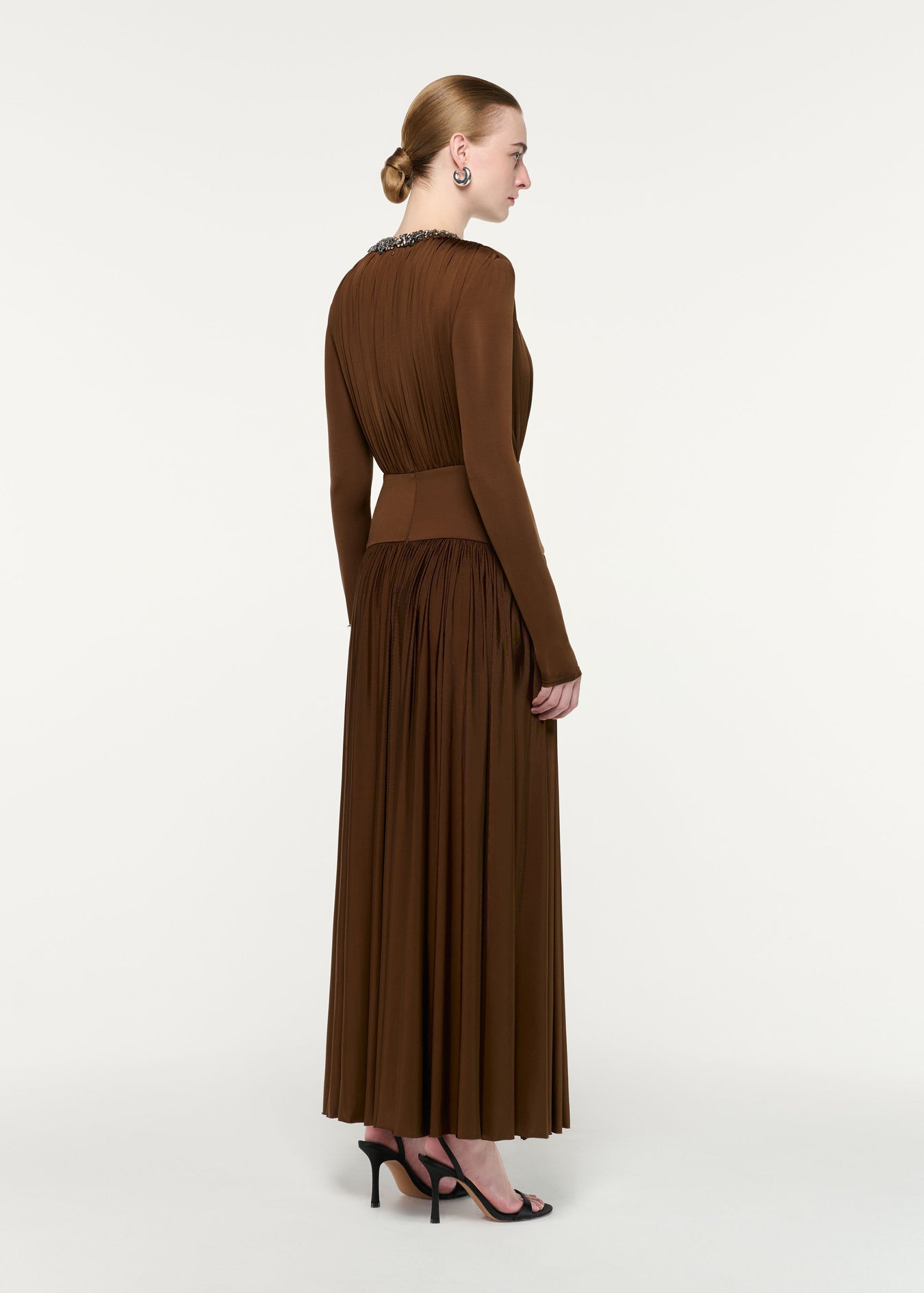 Back view of a model wearing the Embellished Neck Long Sleeve Gathered Dress
