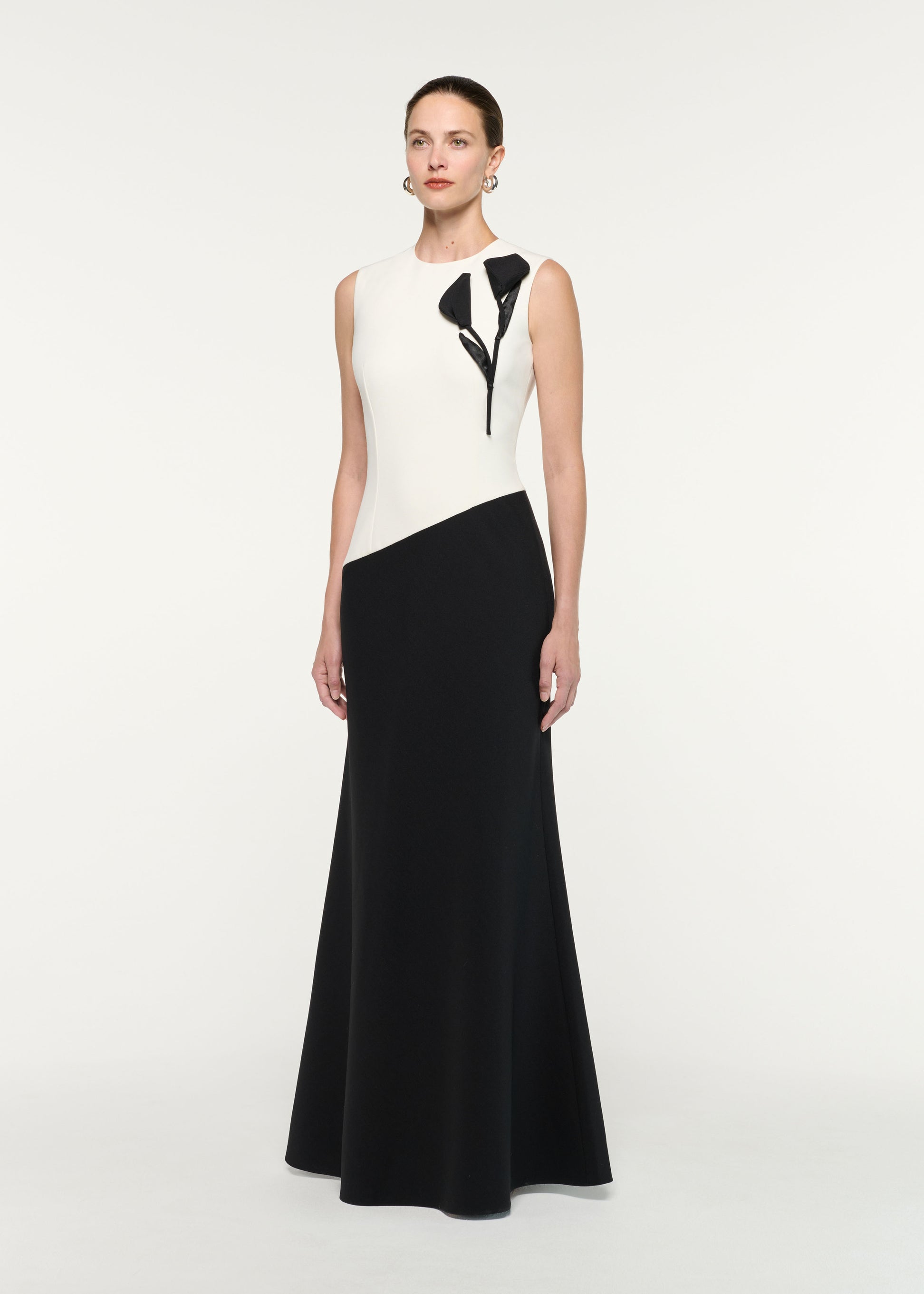 Side view of a model wearing the Flower Embroidery Sleeveless Gown