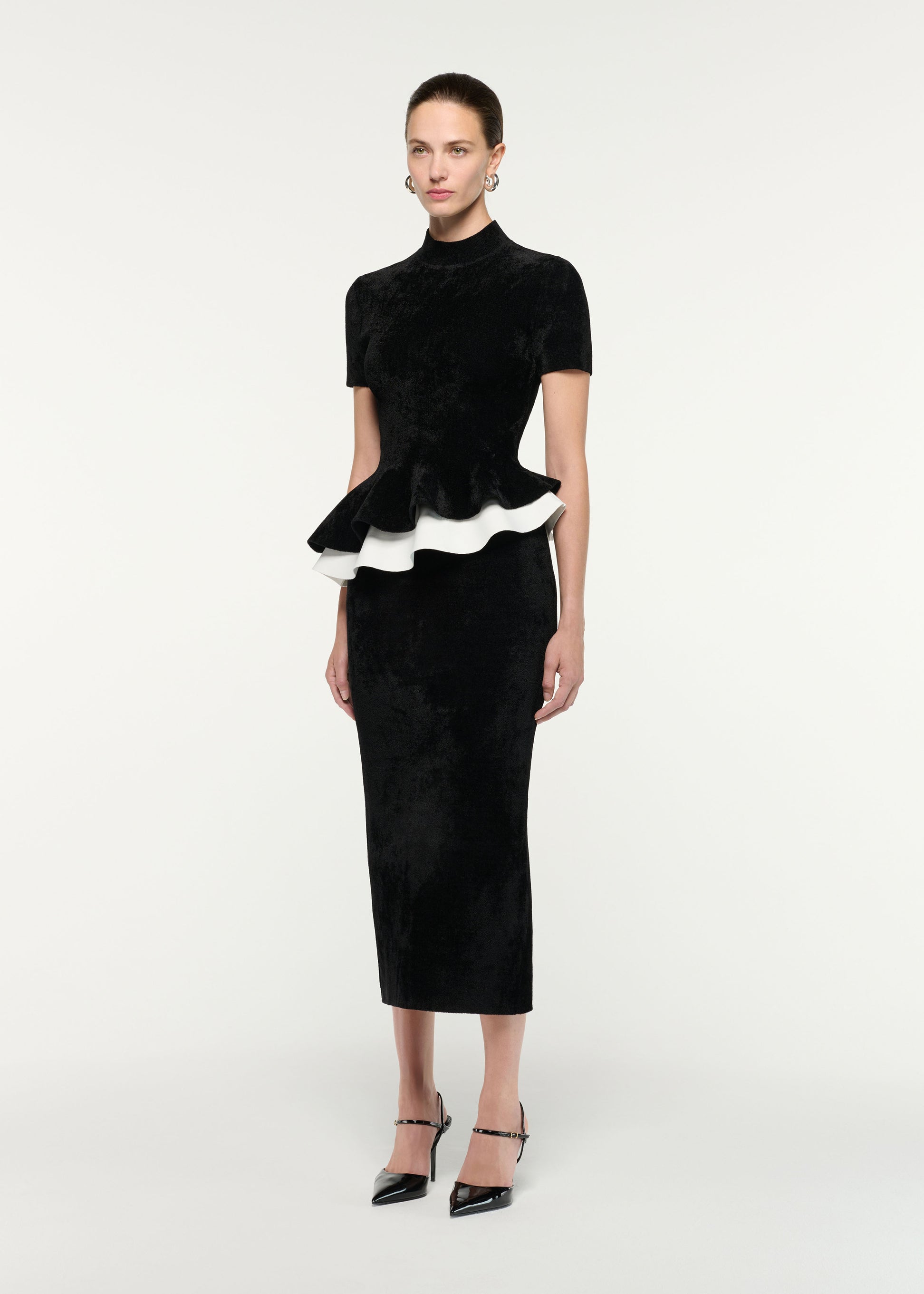 Side view of a model wearing the Short Sleeve Chenille Peplum Midi Dress