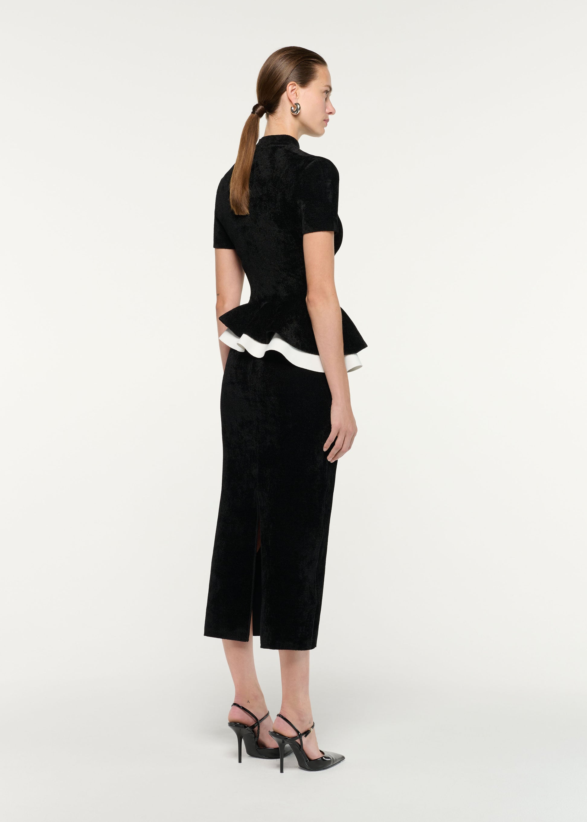 Back view of a model wearing the Short Sleeve Chenille Peplum Midi Dress