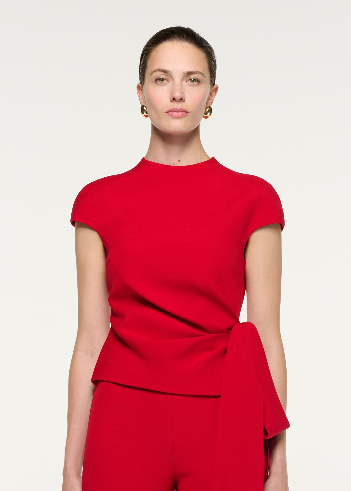 Close up of a model wearing the High Neck Wool Silk Bow Detail Top
