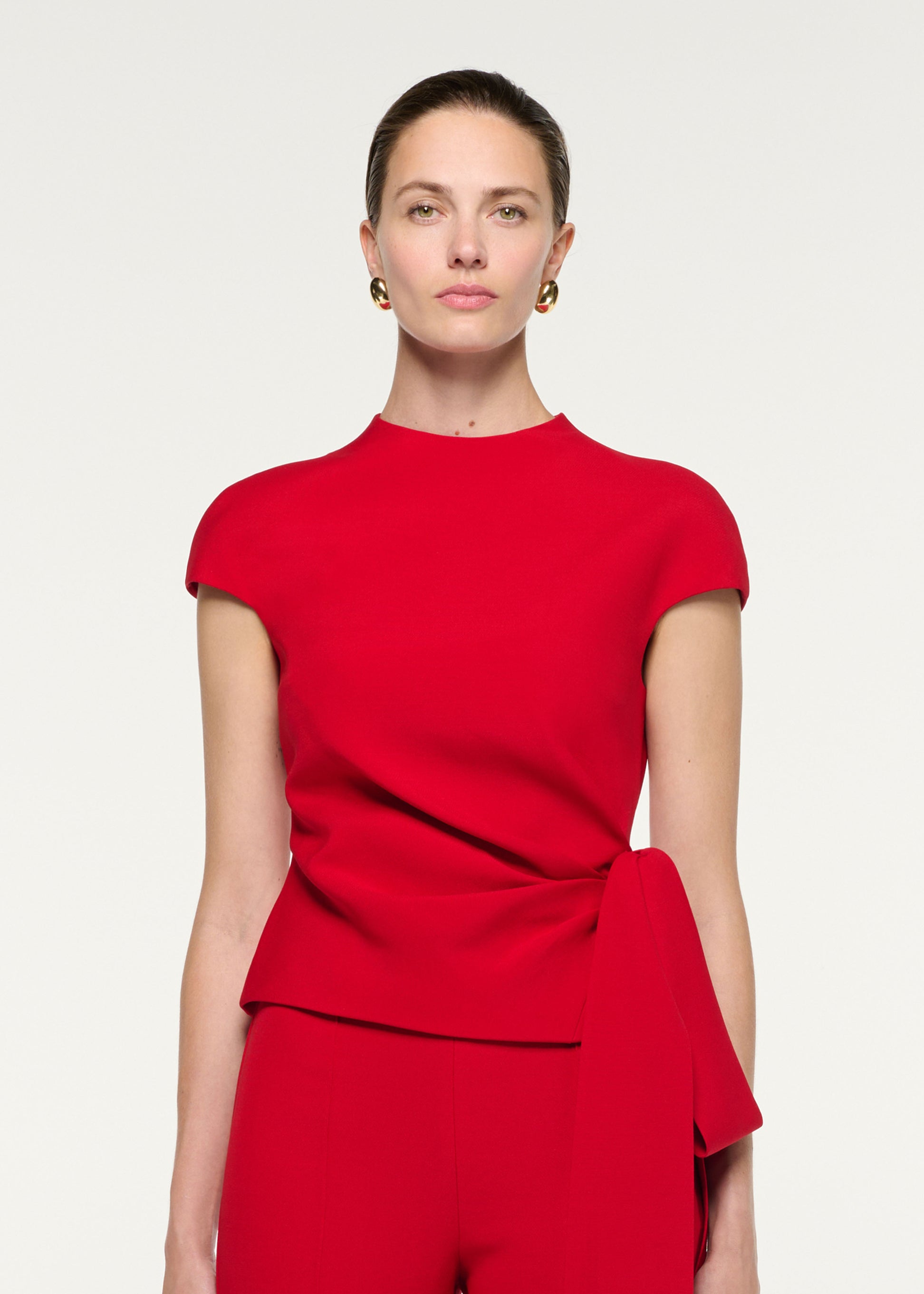 Close up of a model wearing the High Neck Wool Silk Bow Detail Top