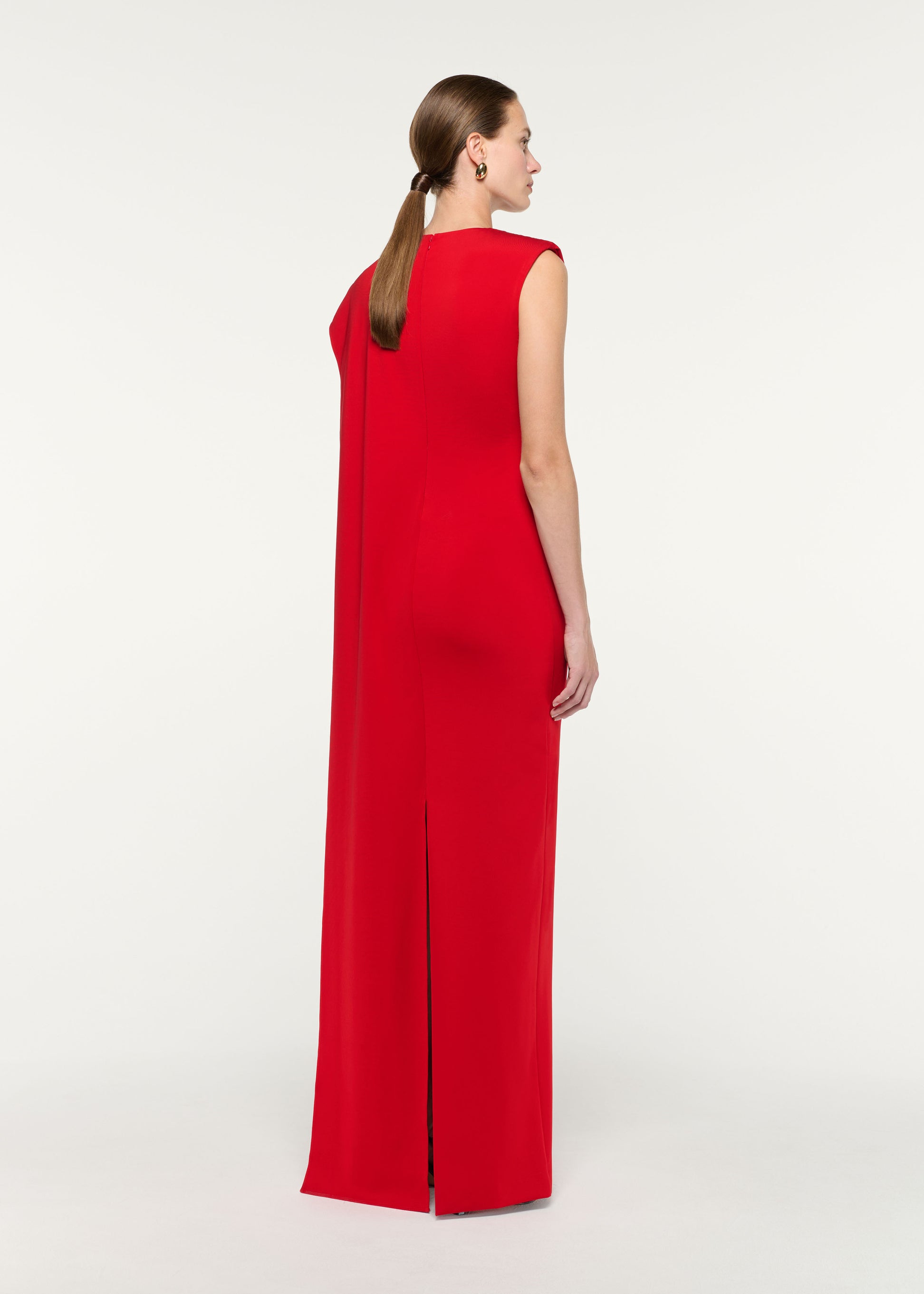 Back view of a model wearing the Asymmetric Cape Gown