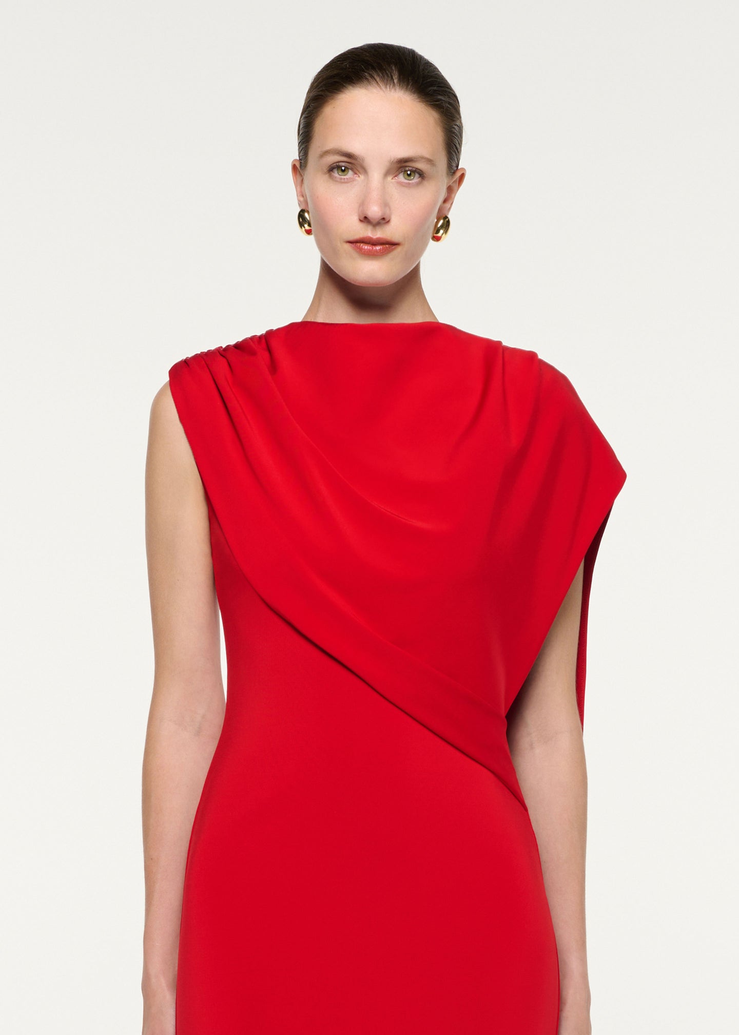 Close up of a model wearing the Asymmetric Cape Gown