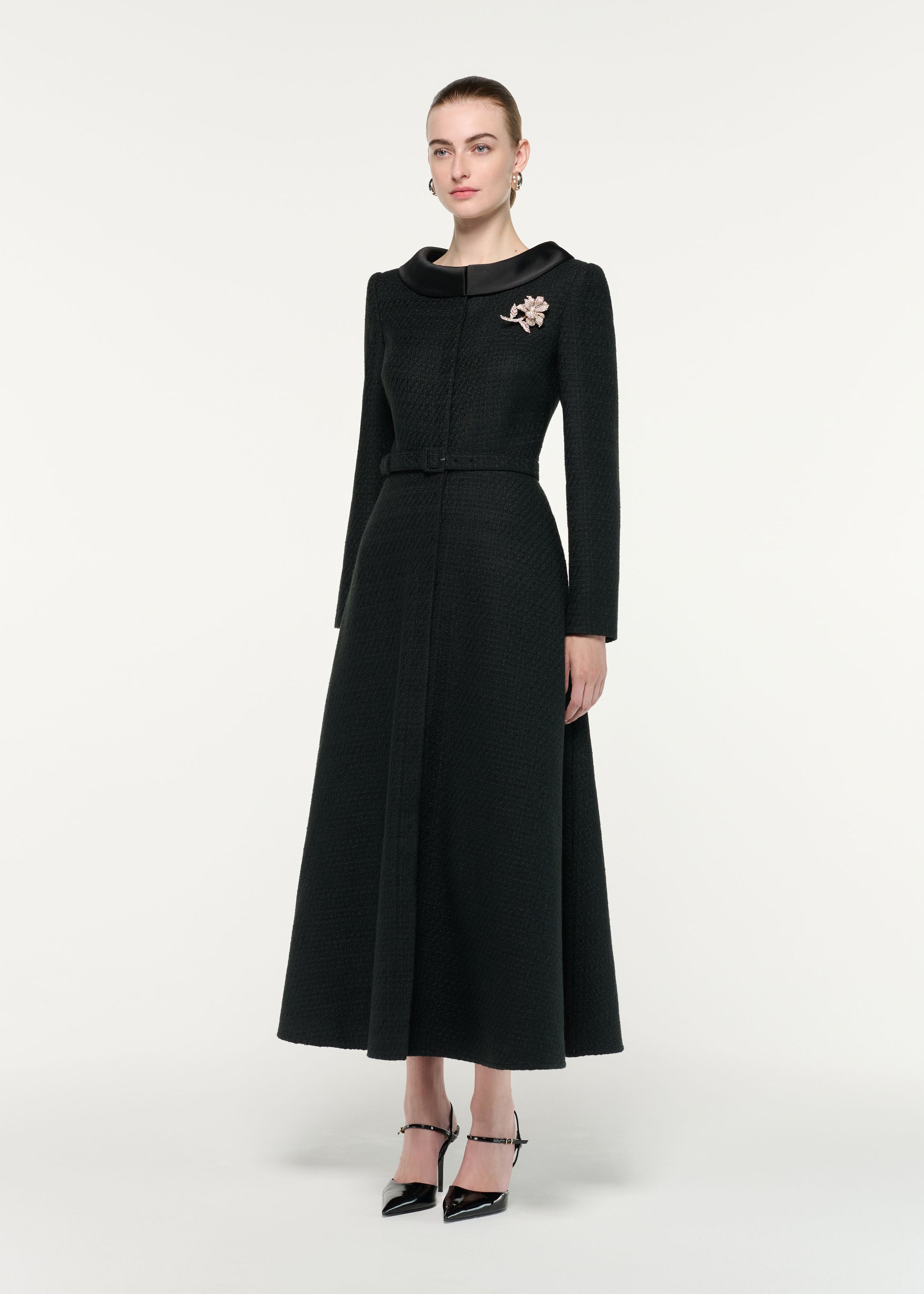 Side view of a model wearing the Boucle Coat With Flower Brooch