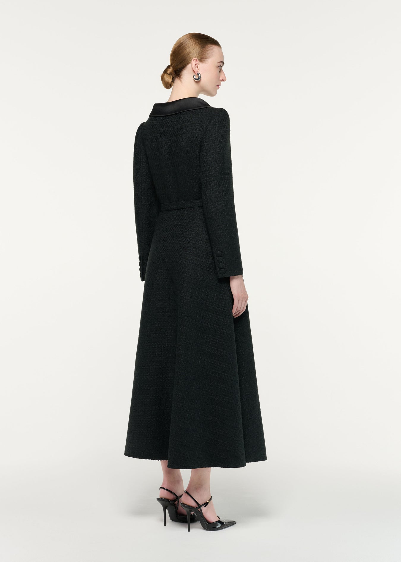 Back view of a model wearing the Boucle Coat With Flower Brooch