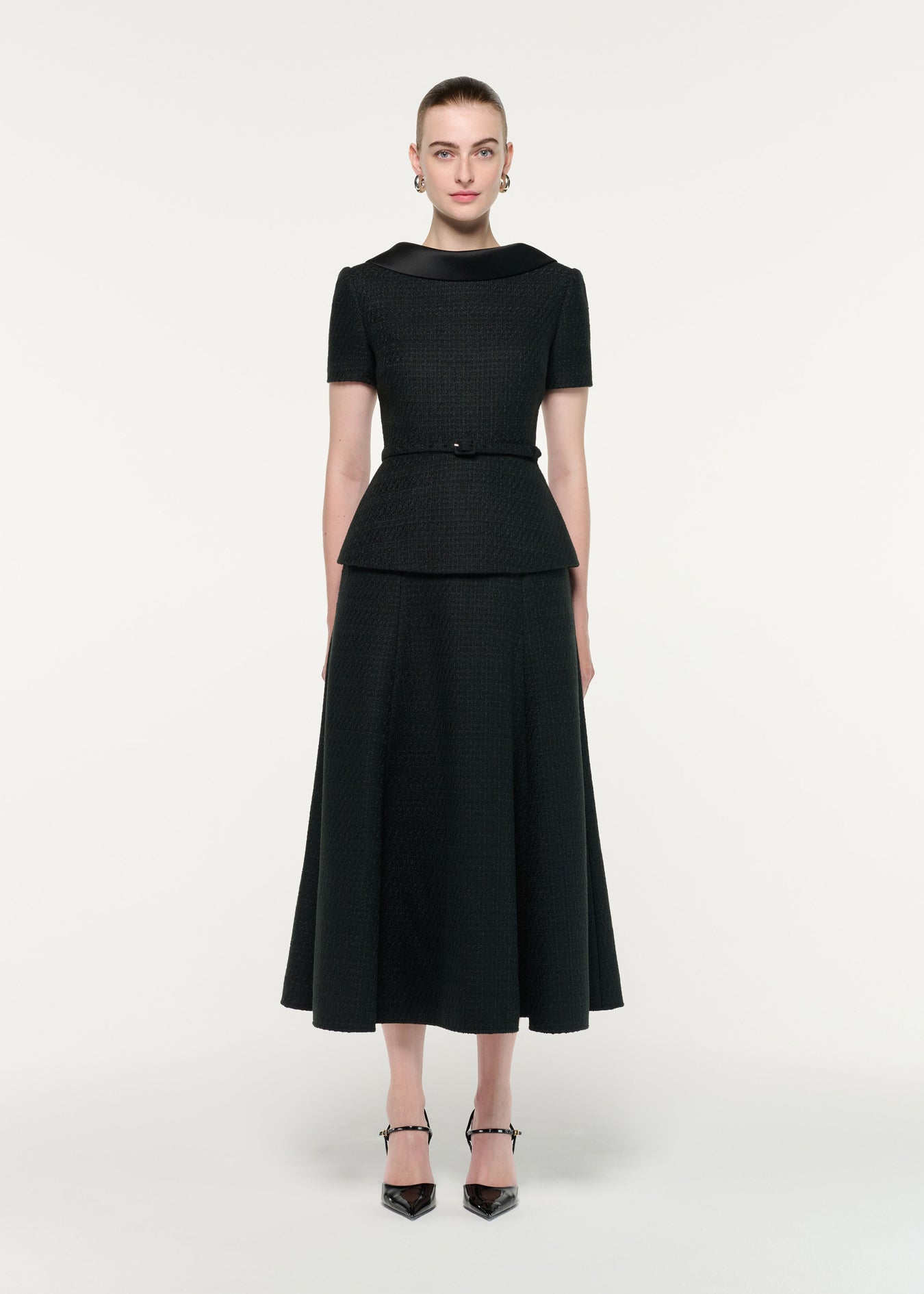 Front view of a model wearing the Collared Boucle Peplum Midi Dress