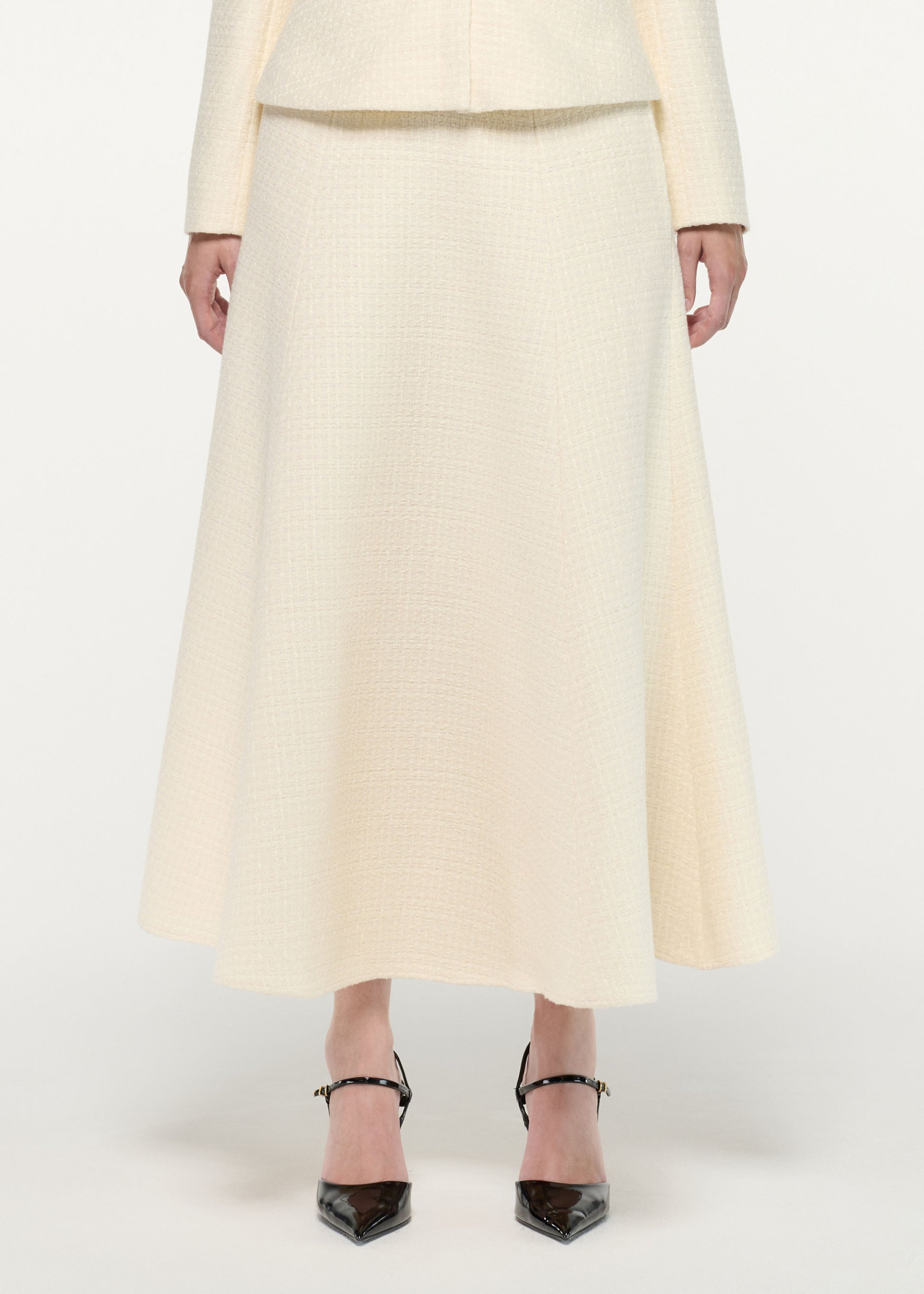 Close up of a model wearing the Boucle Midi Flared Skirt