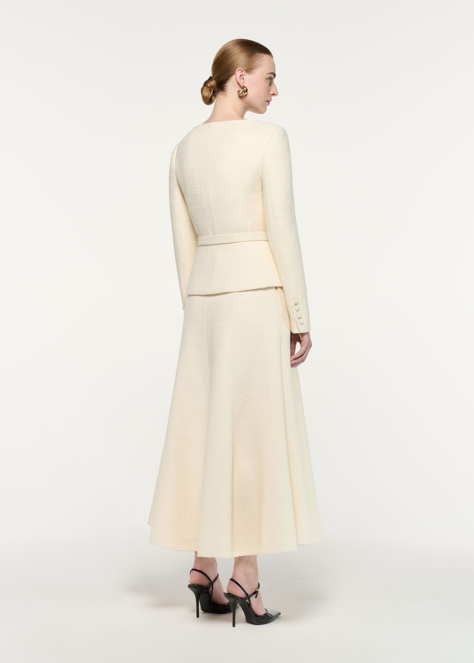 Back view of a model wearing the Flower Brooch Boucle Jacket