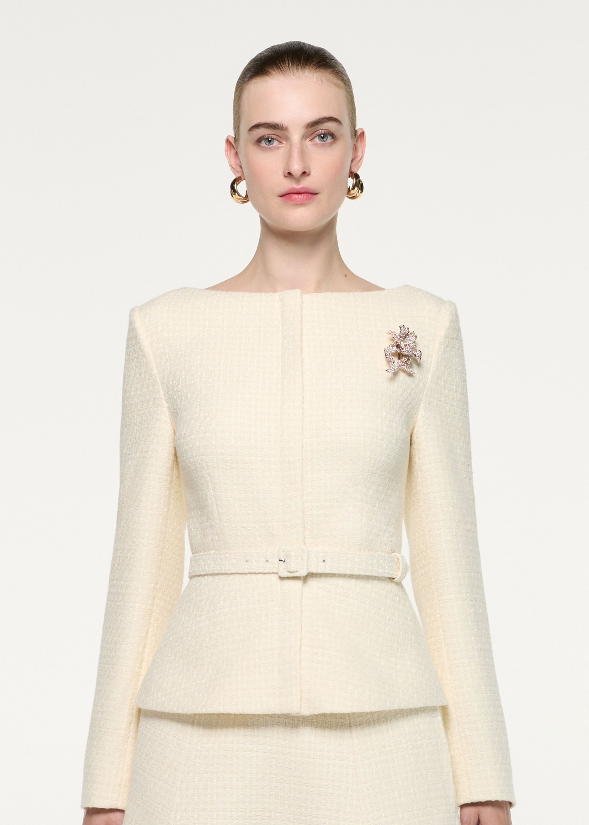 Close up of a model wearing the Flower Brooch Boucle Jacket