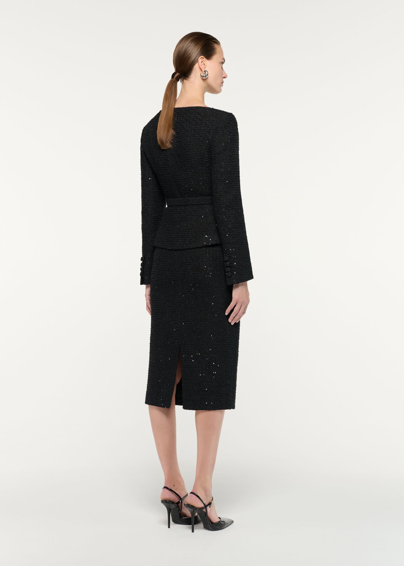 Back view of a model wearing the Flower Brooch Sequin Boucle Jacket