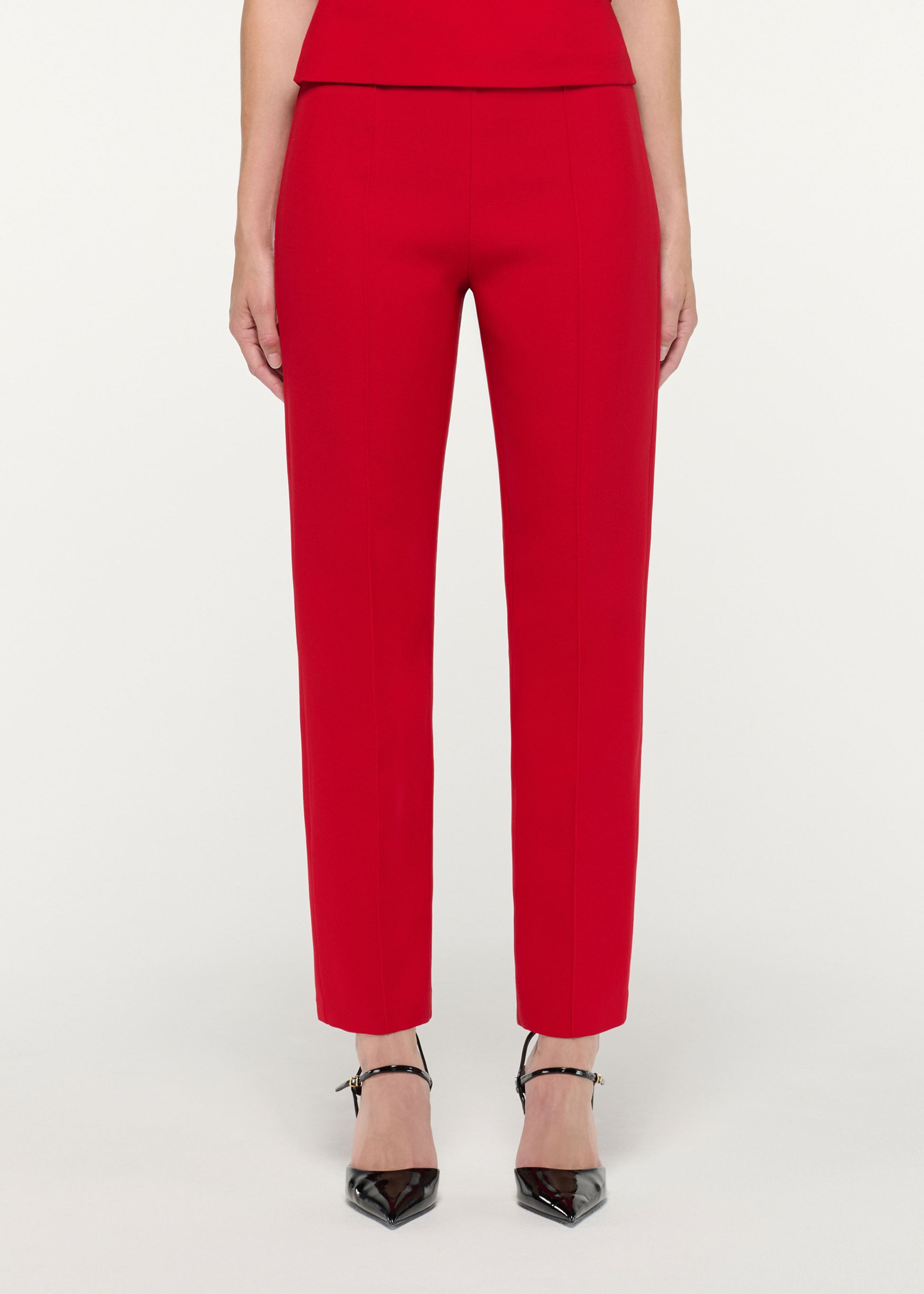 Close up of a model wearing the Red Wool Silk Cropped Trouser