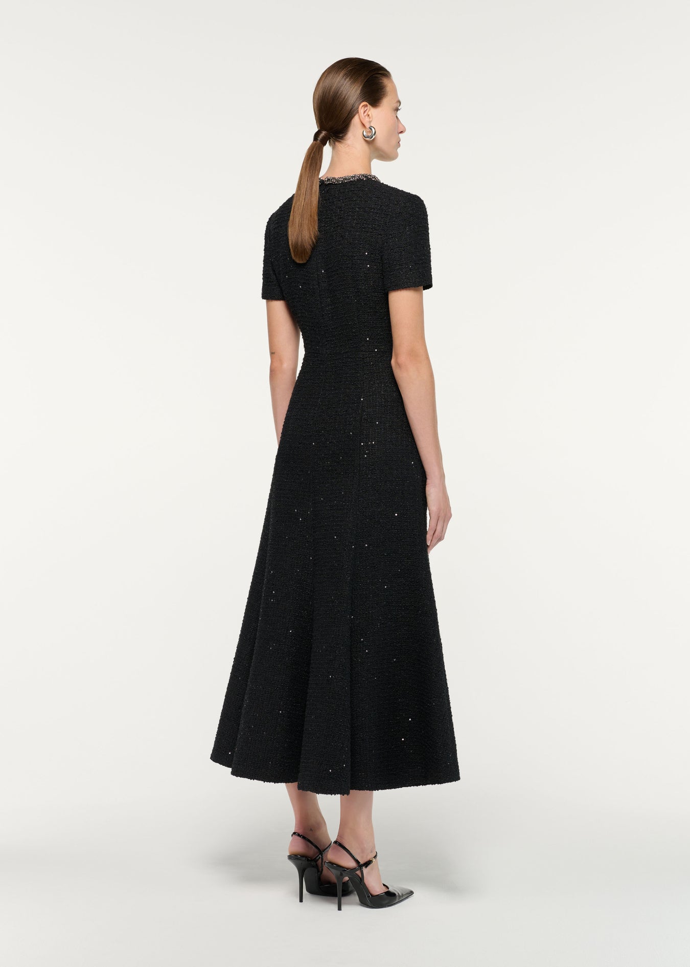 Back view of a model wearing the Embellished Neck Sequin Boucle Midi Dress