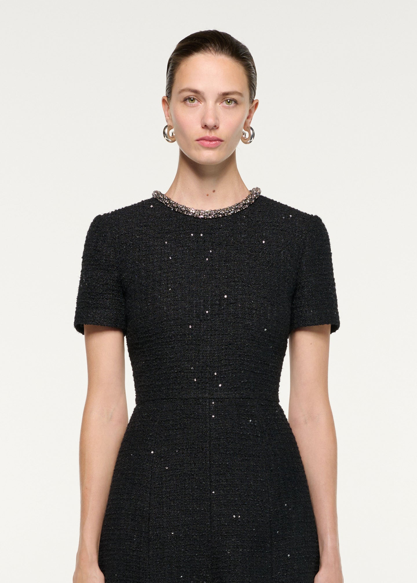 Close up of a model wearing the Embellished Neck Sequin Boucle Midi Dress