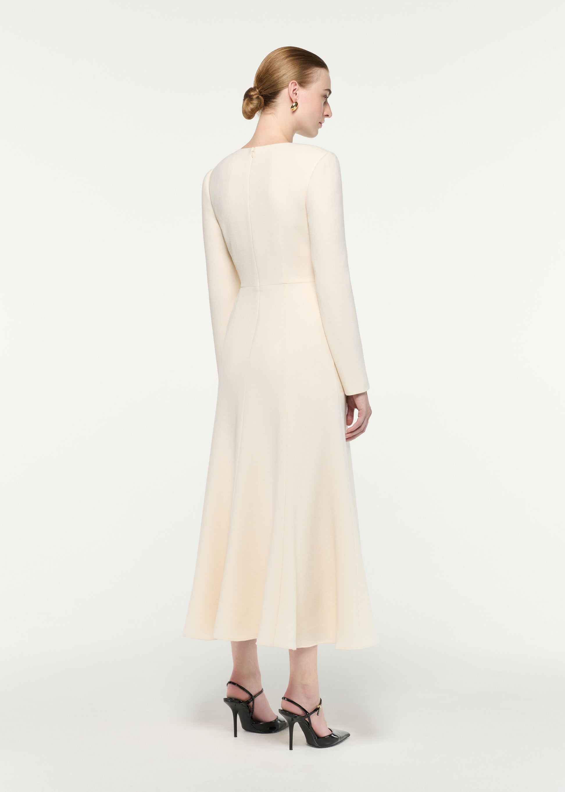 Back view of a model wearing the Asymmetric Bow Neck Wool Crepe Midi Dress