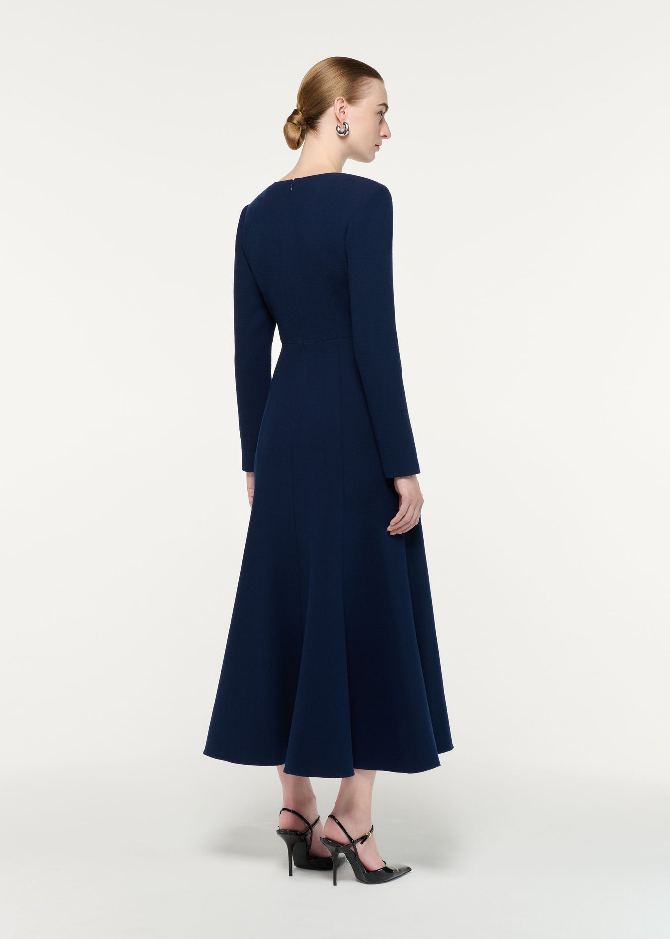 Back view of a model wearing the Asymmetric Bow Neck Wool Crepe Midi Dress
