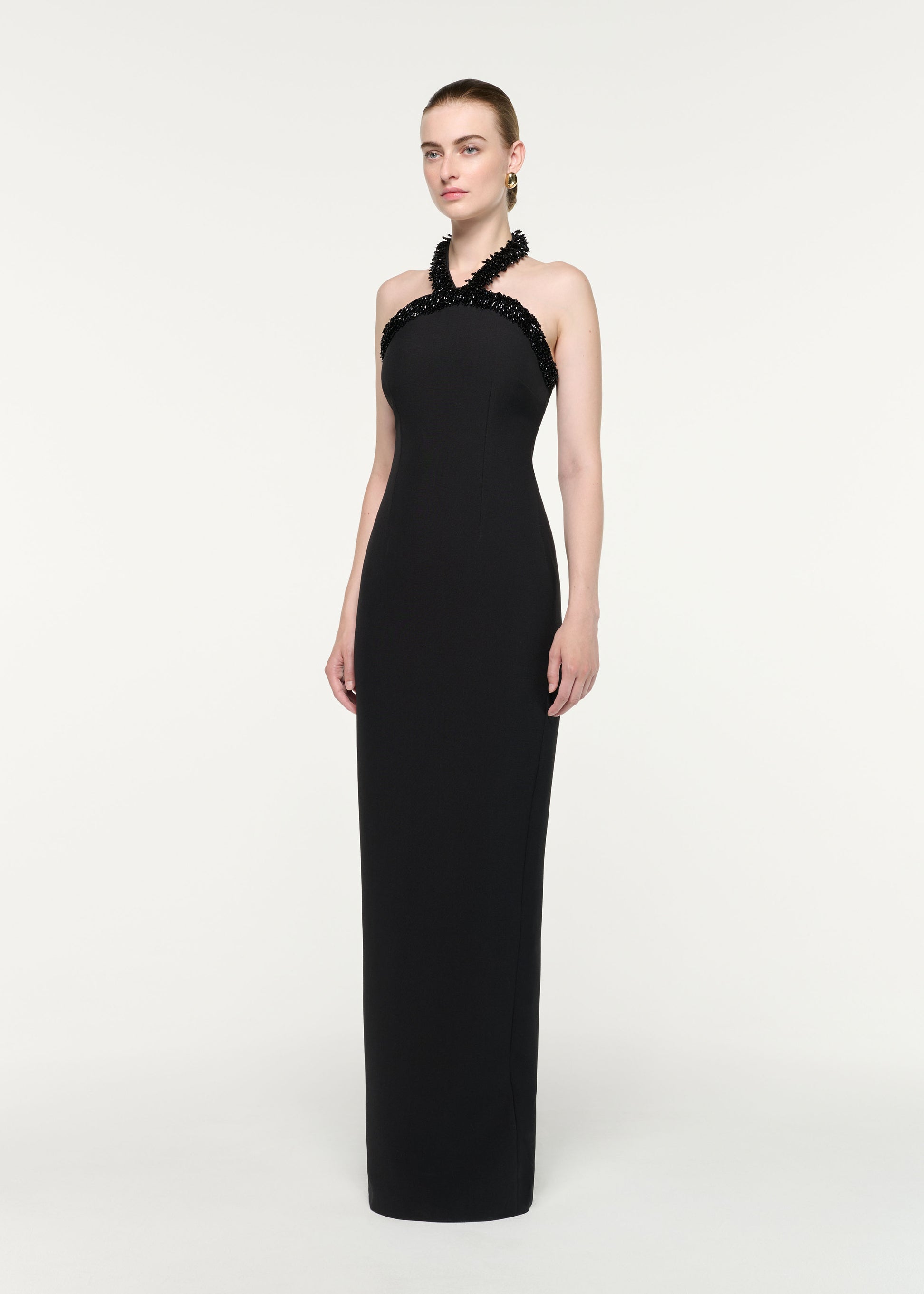 Side view of a model wearing the Embellished Halter Neck Crepe Gown
