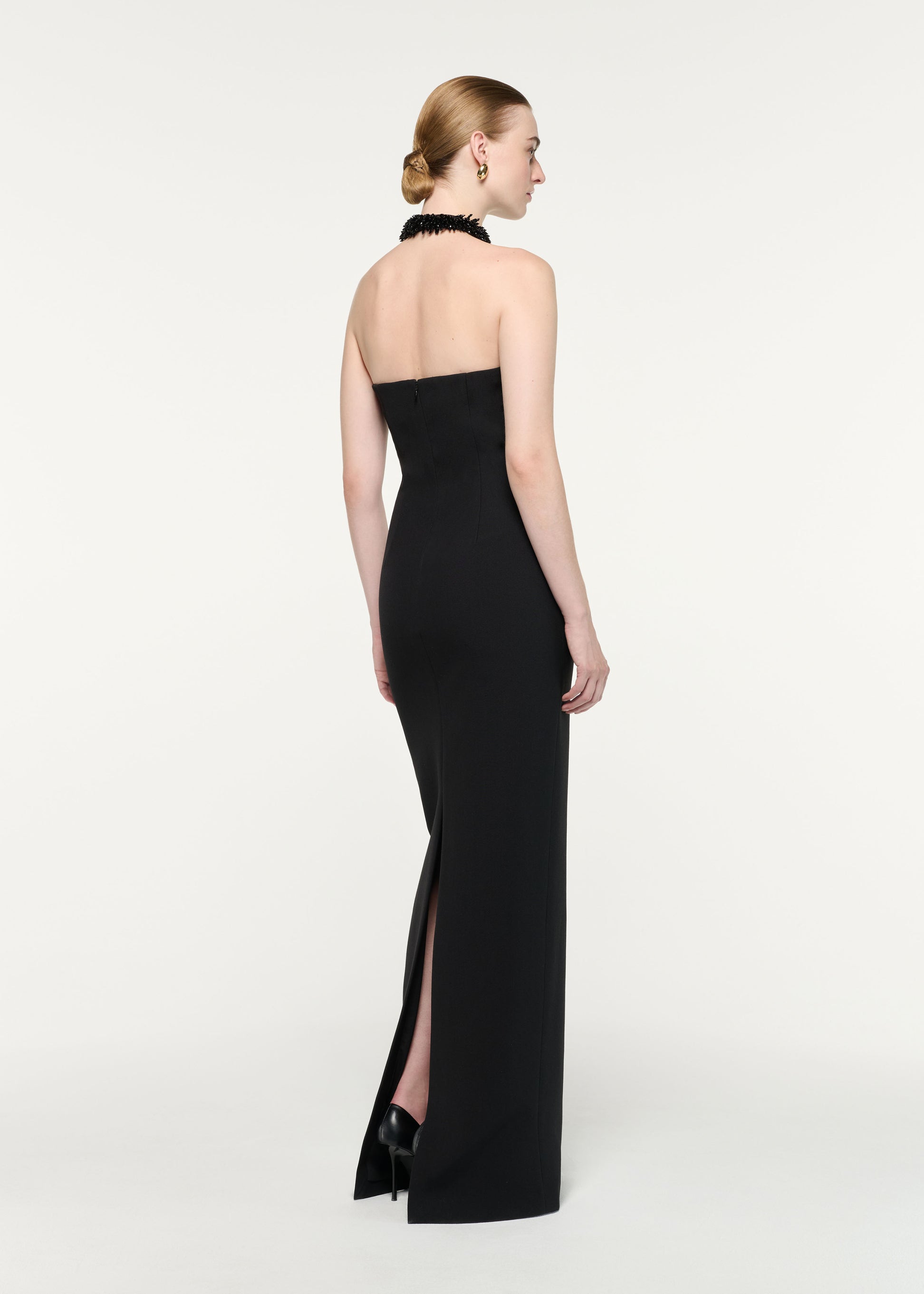 Back view of a model wearing the Embellished Halter Neck Crepe Gown