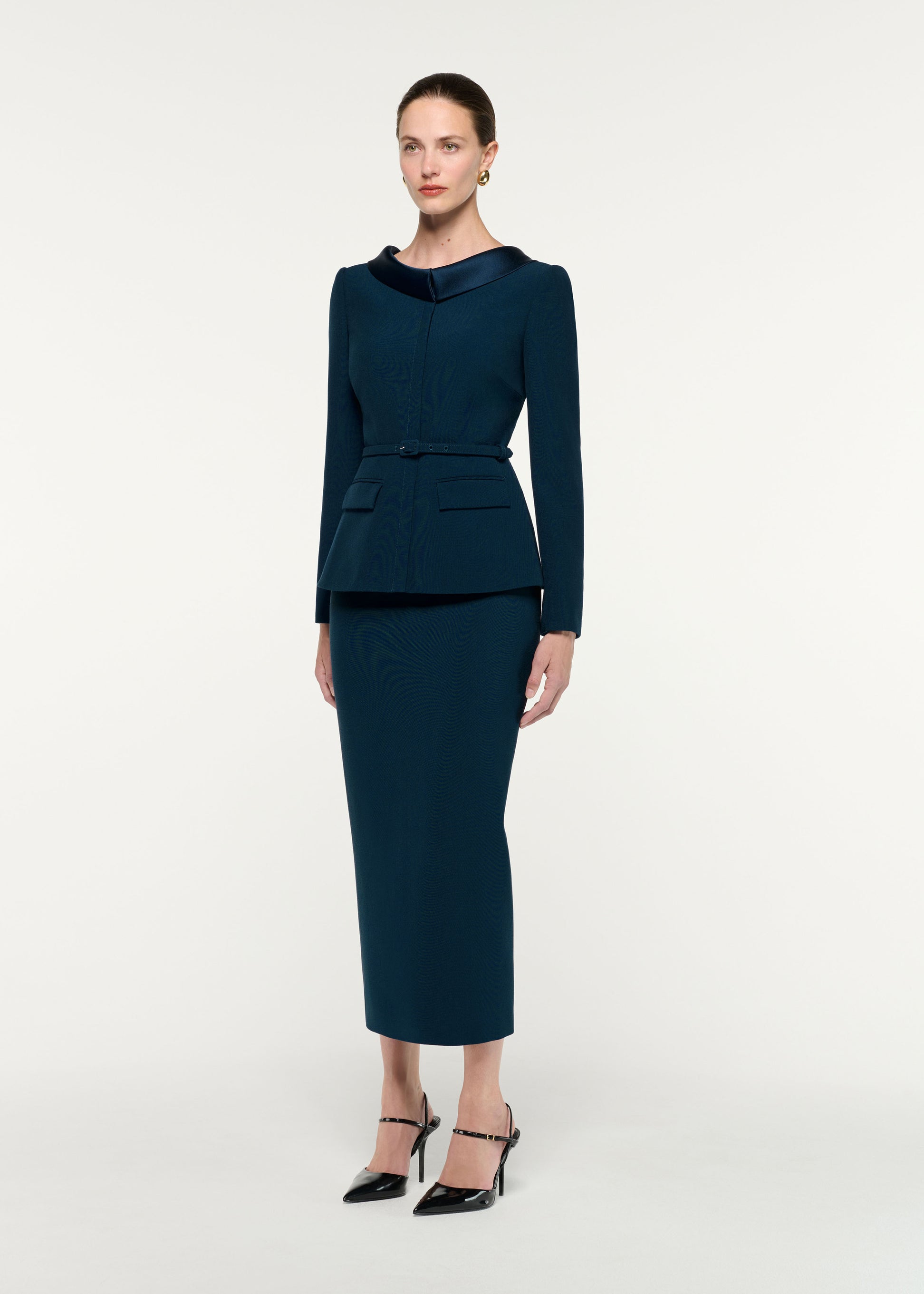 Side view of a model wearing the Crepe Midi Skirt