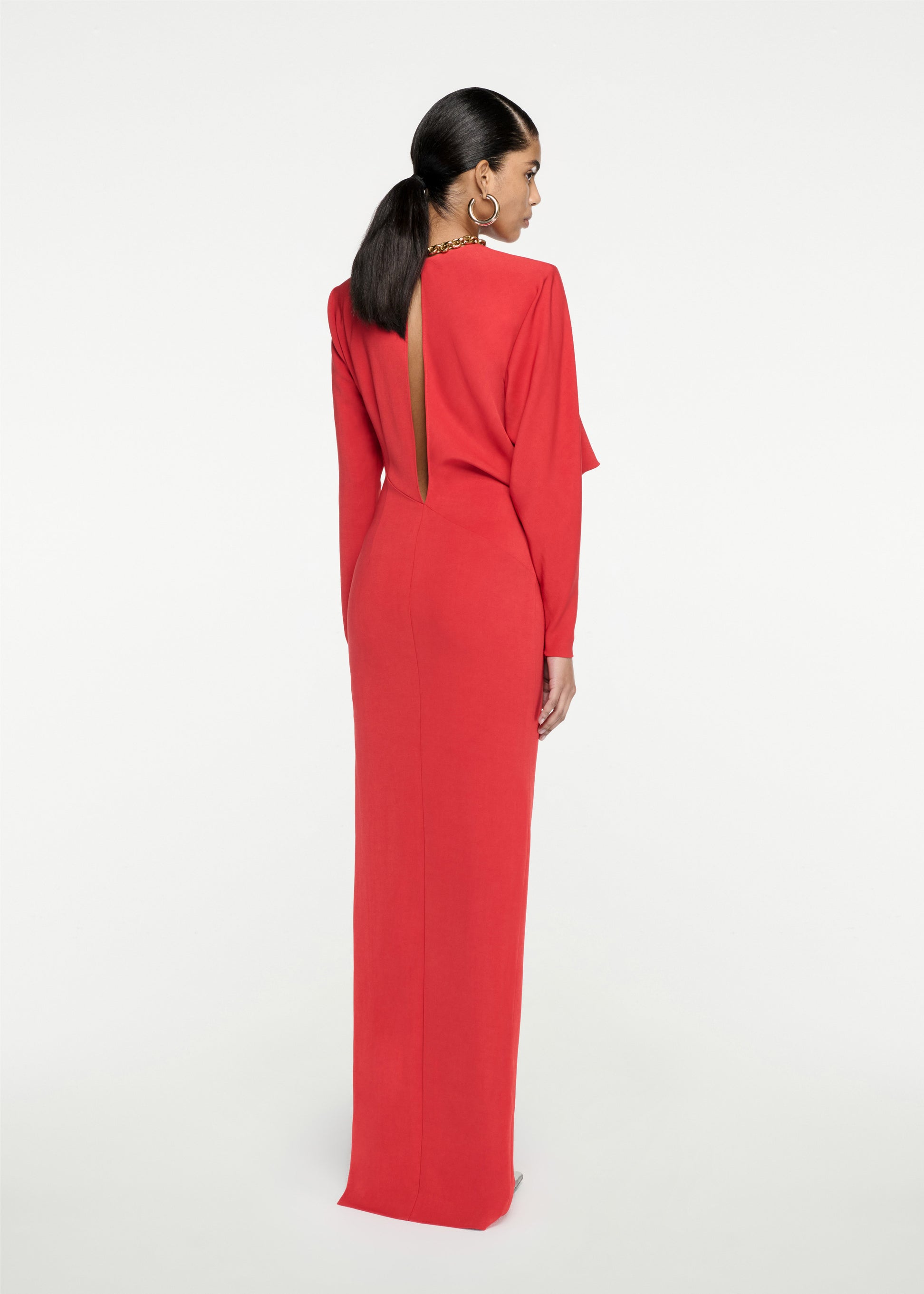 The back of a woman wearing the Long Sleeve Stretch Cady Maxi Dress in Red