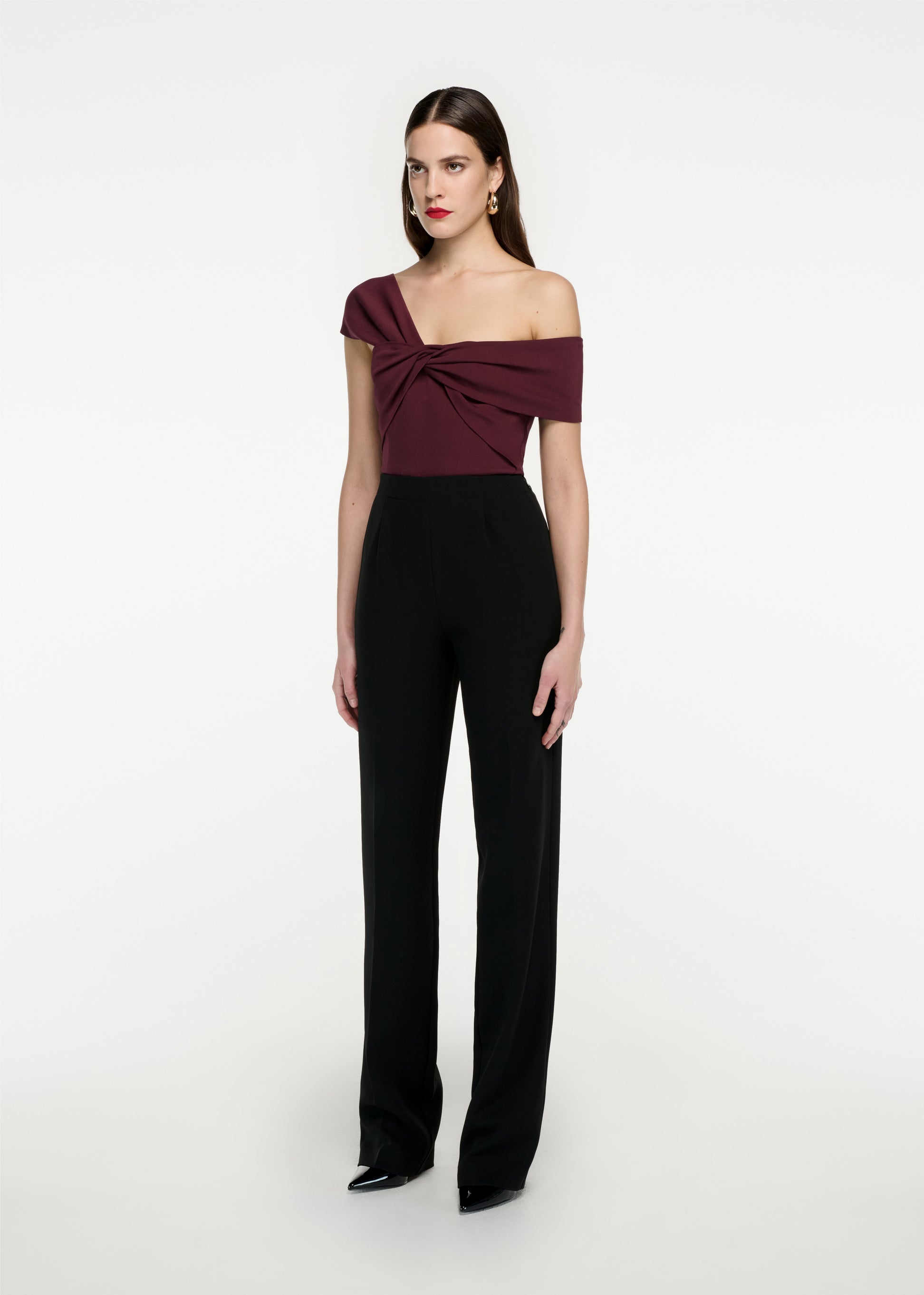 Woman wearing the Asymmetric Stretch Cady Top in Maroon