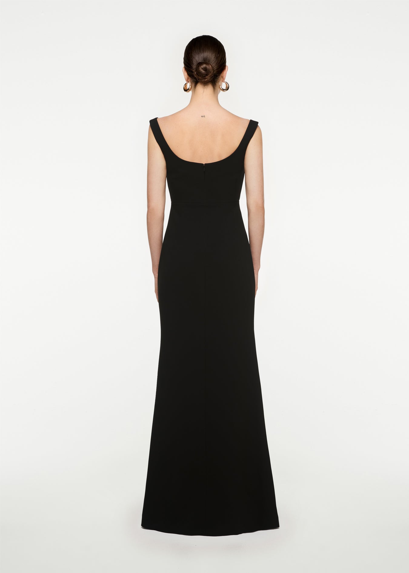 The back of a woman wearing the Off Shoulder Cady Diamante Gown in Black
