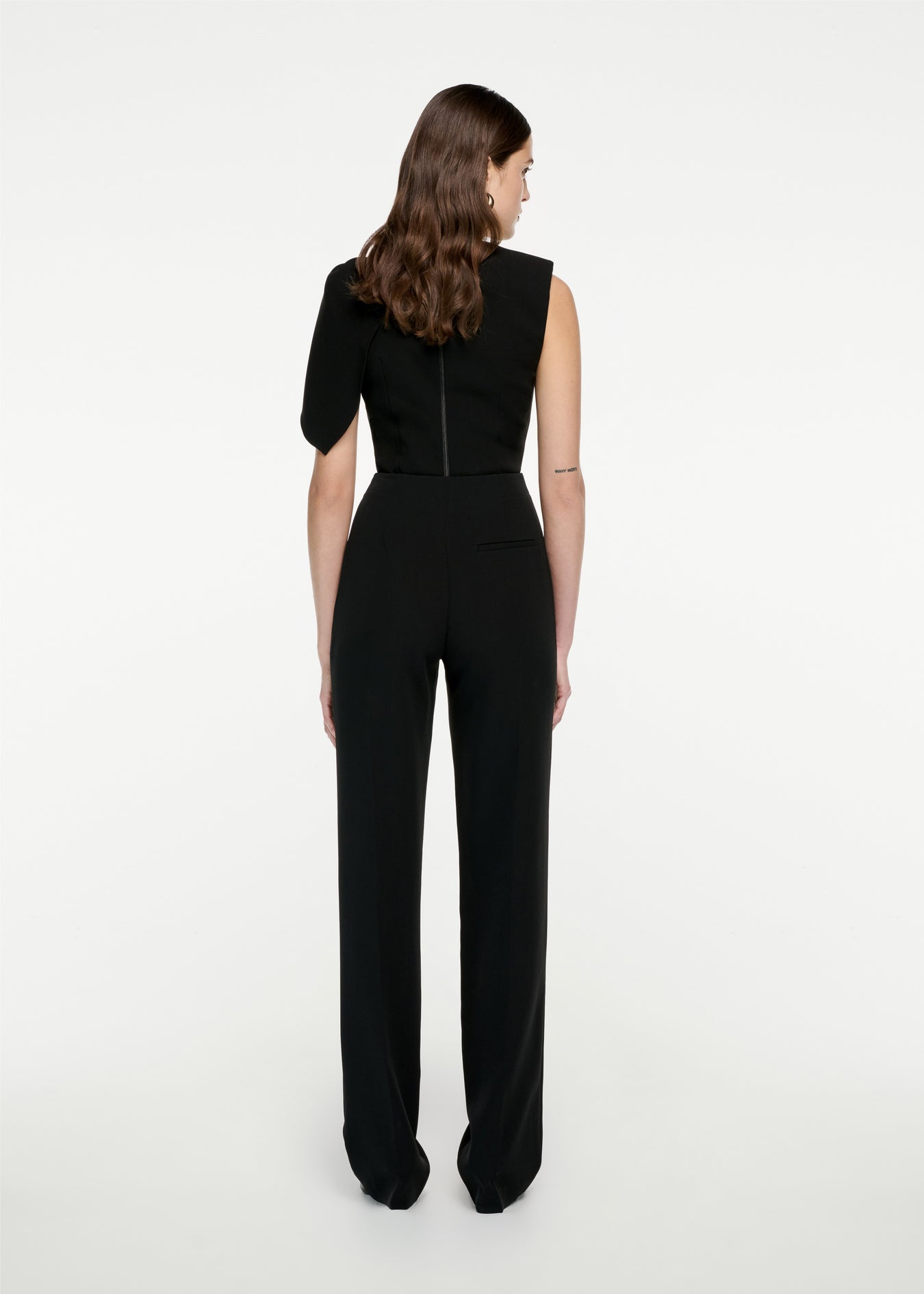 The back of a woman wearing the Stretch Cady Top in Black