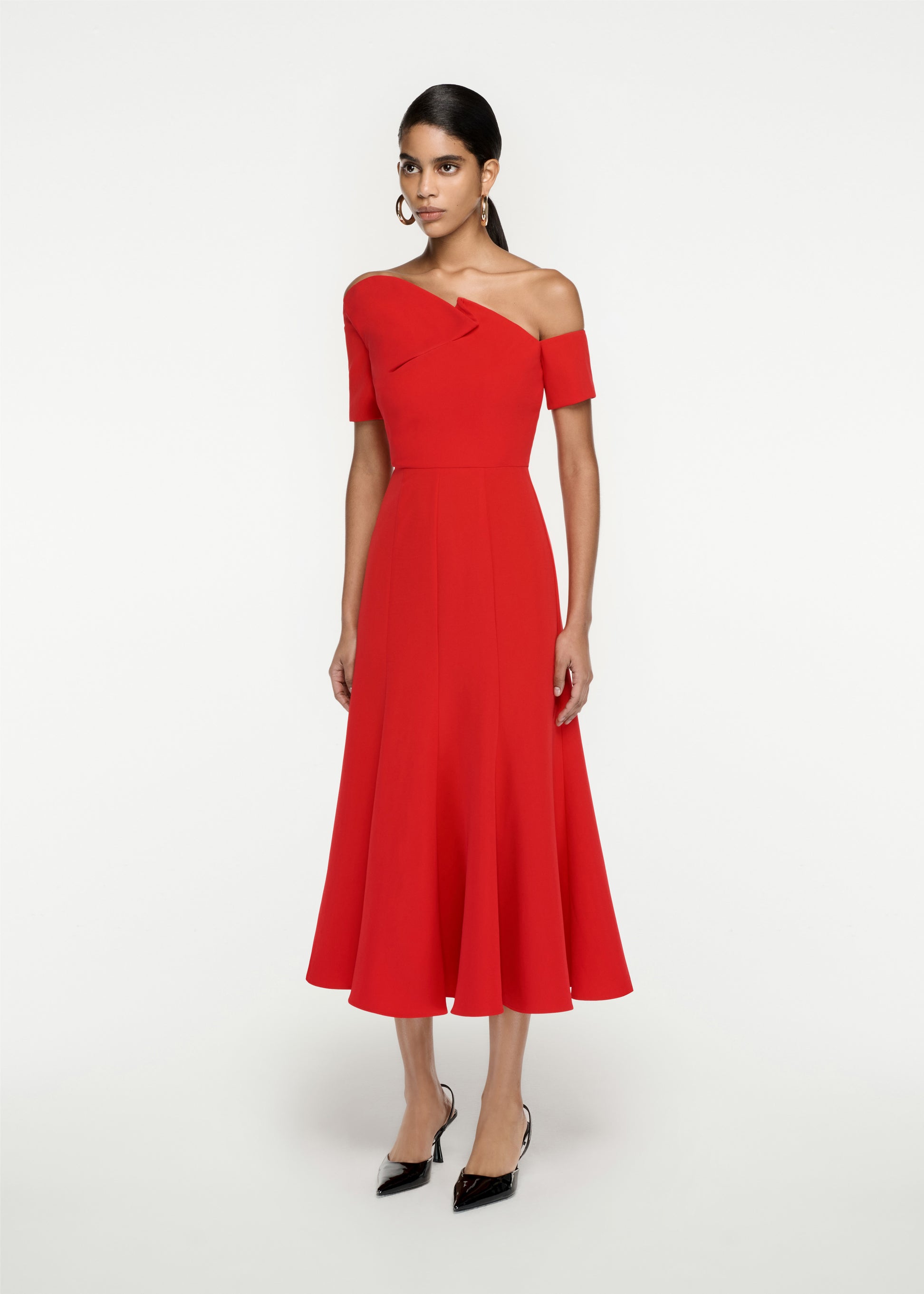 Woman wearing the Asymmetric Stretch Cady Midi Dress in Red