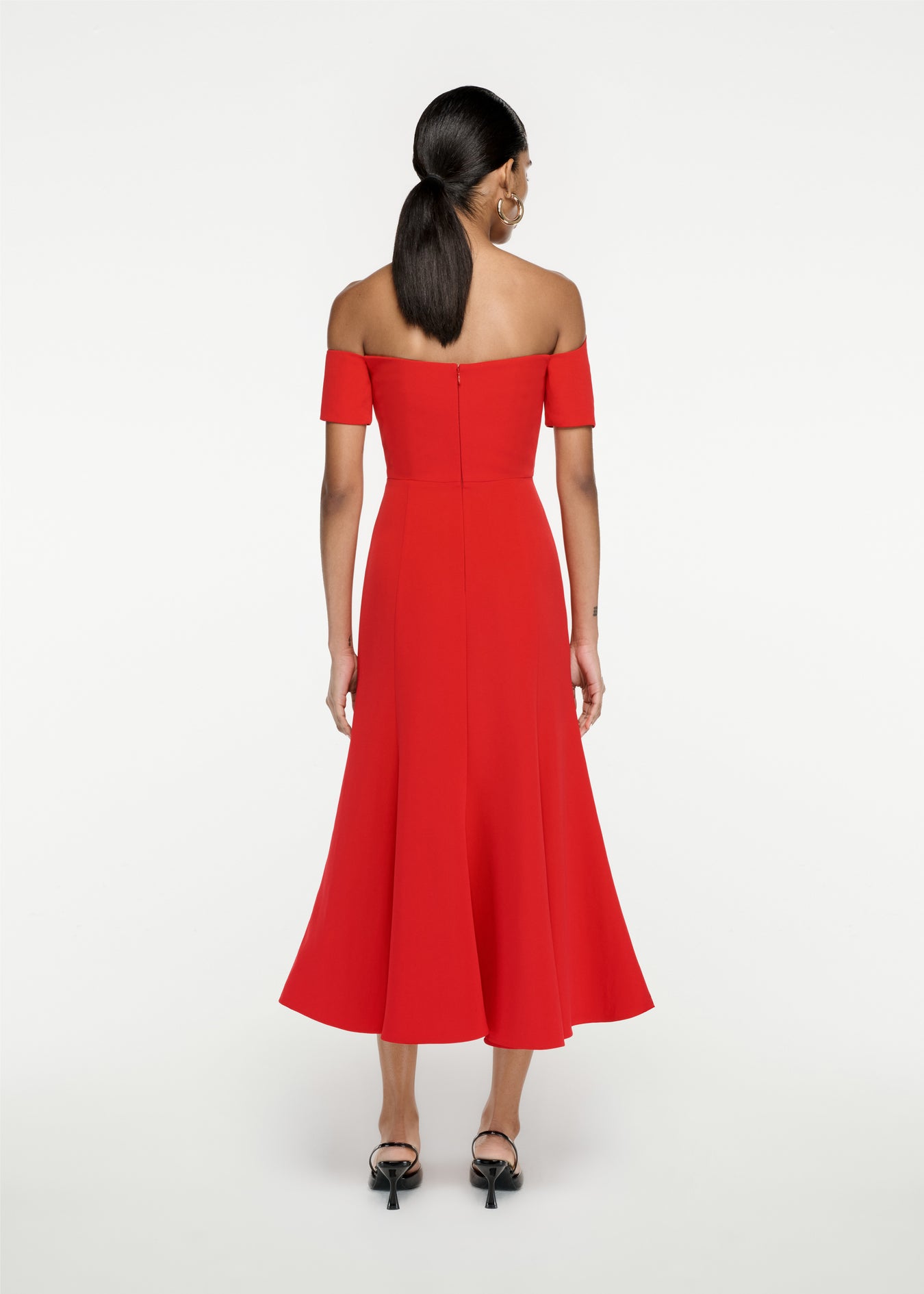 The back of a woman wearing the Asymmetric Stretch Cady Midi Dress in Red