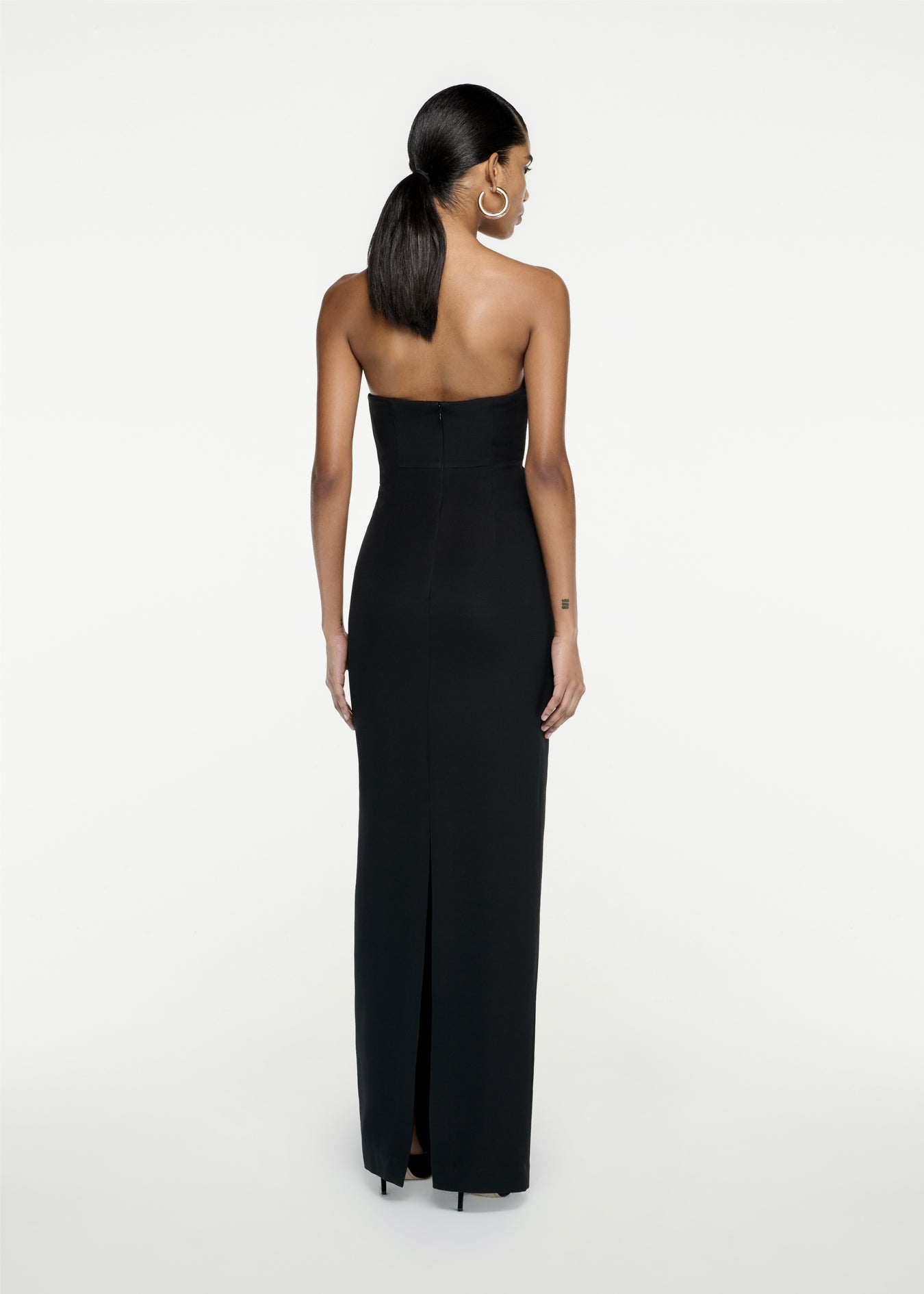 The back of a woman wearing the Strapless Silk Wool Diamante Maxi Dress in Black