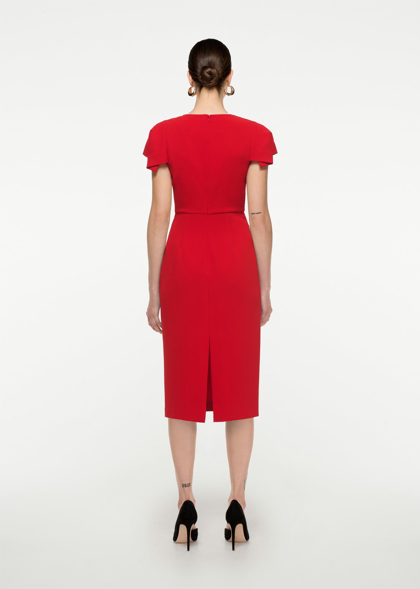 The back of a woman wearing the Cap Sleeve Stretch Cady Midi Dress in Red
