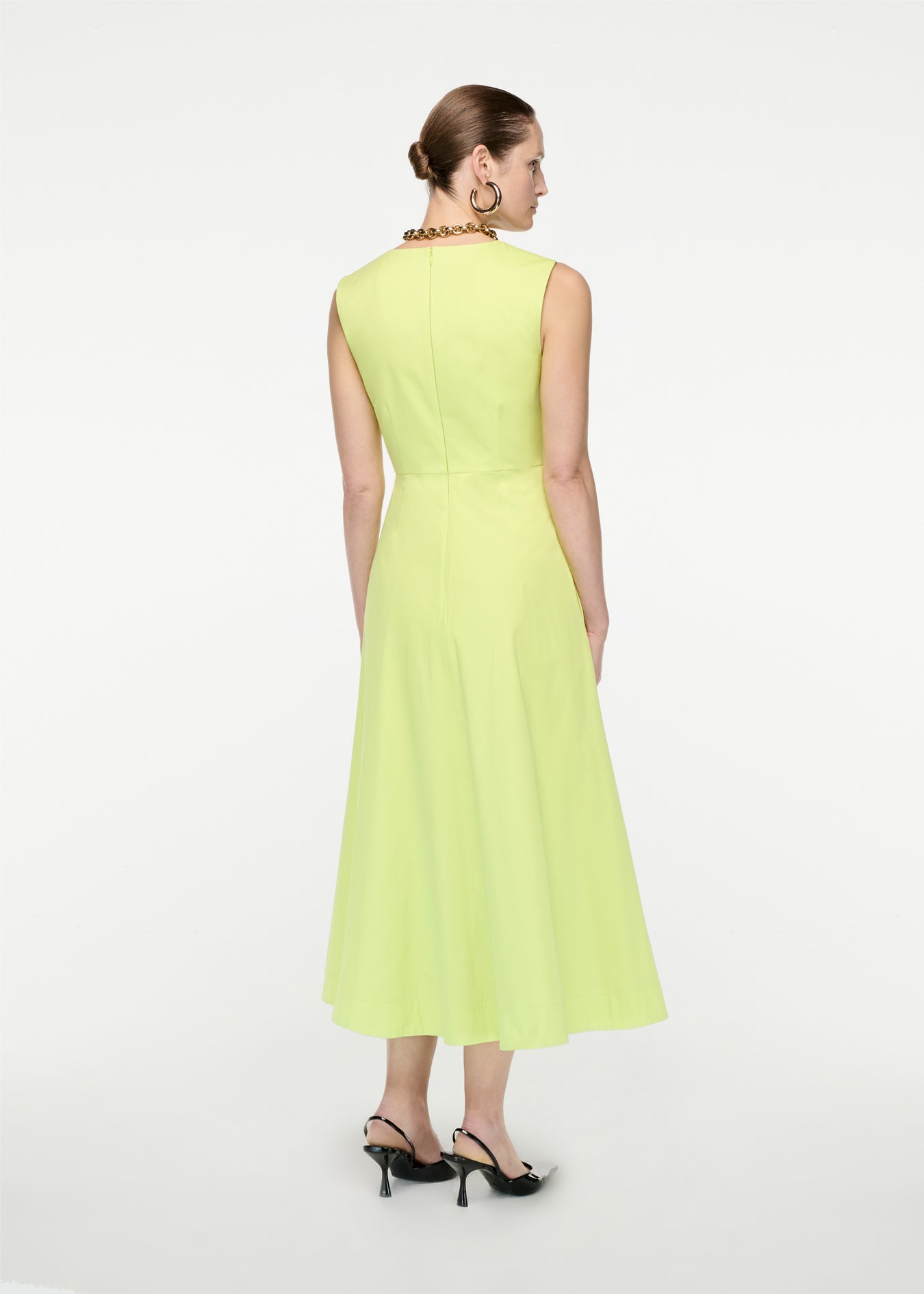 The back of a woman wearing the Cotton Poplin Midi Dress in Yellow