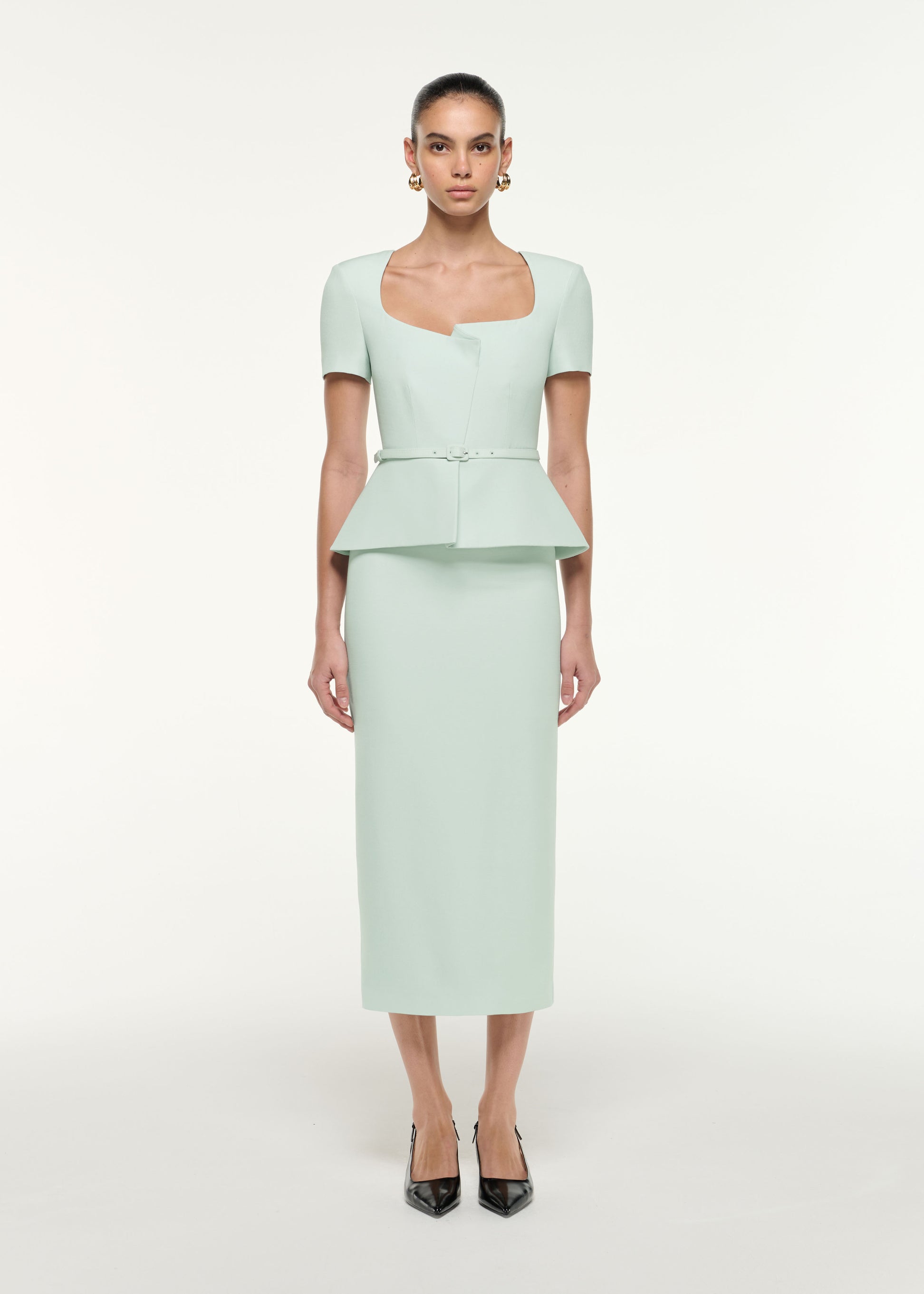 Front view of a model wearing the Peplum Wool Silk Midi Dress in Mint