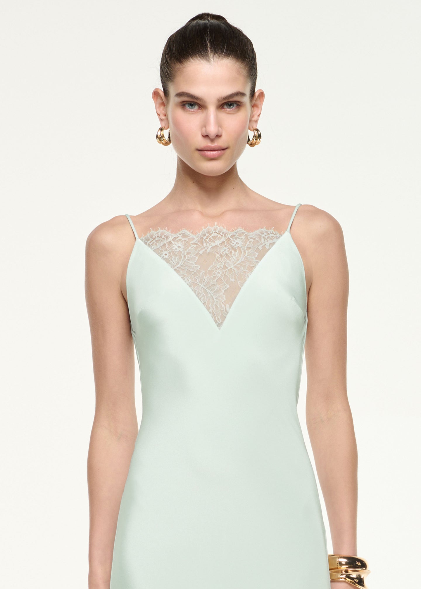 Close up of a model wearing the Silk Lace Gown in Mint