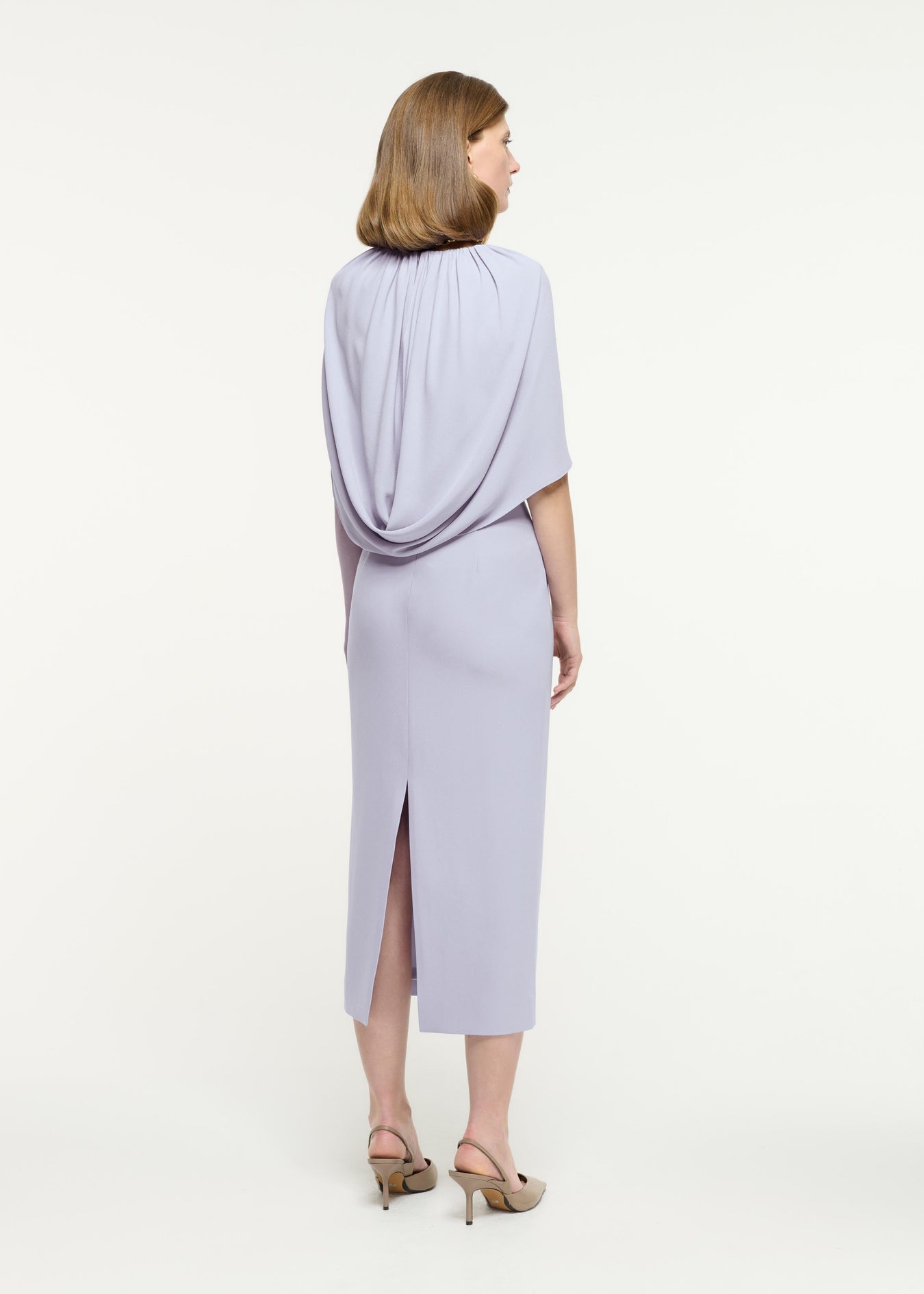 Back view of a model wearing the Satin Crepe Cape Midi Dress in Purple