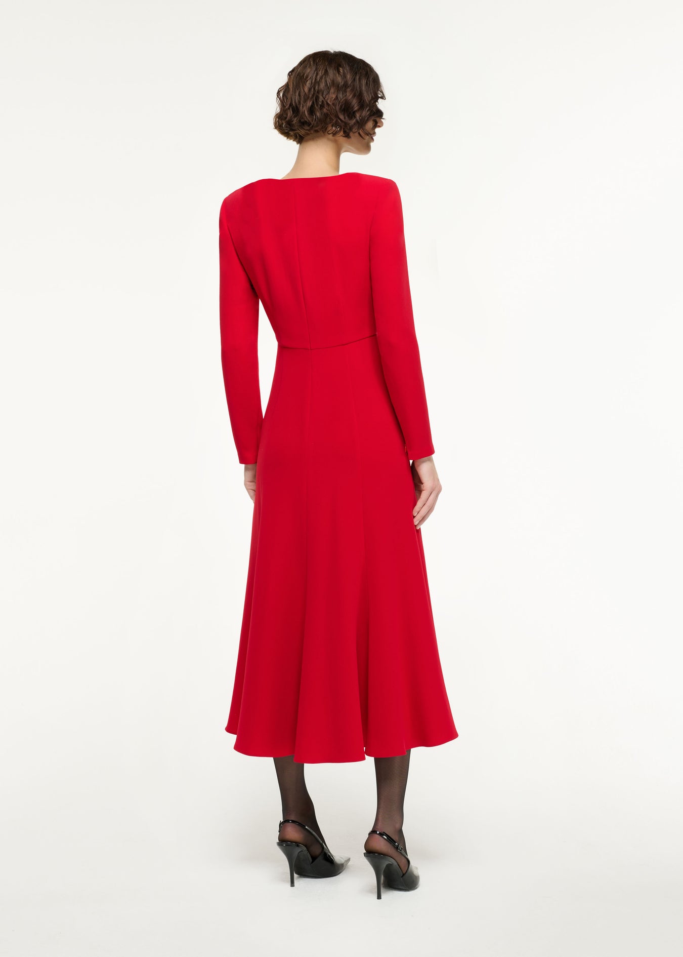 Back view of a model wearing the Long Sleeve Light Cady Midi Dress in Red