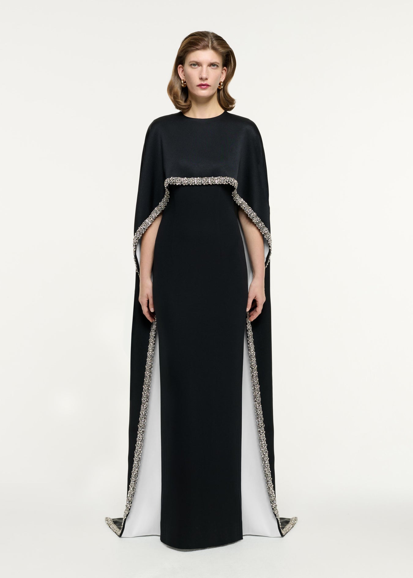 Front view of a model wearing the Embellished Cape Satin Crepe Gown in Monochrome