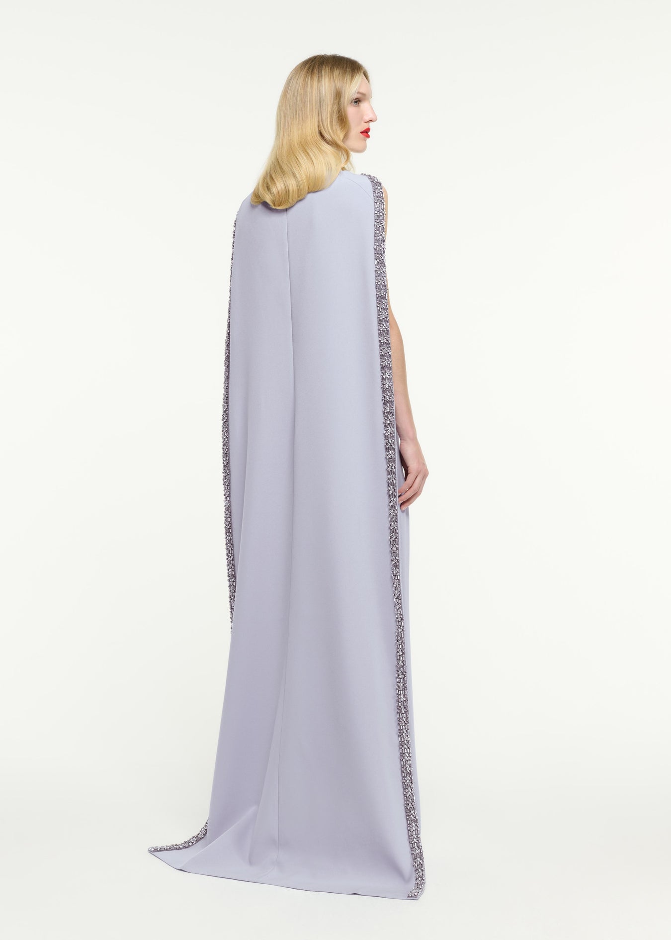 Back view of a model wearing the Embellished Cape Satin Crepe Gown in Purple