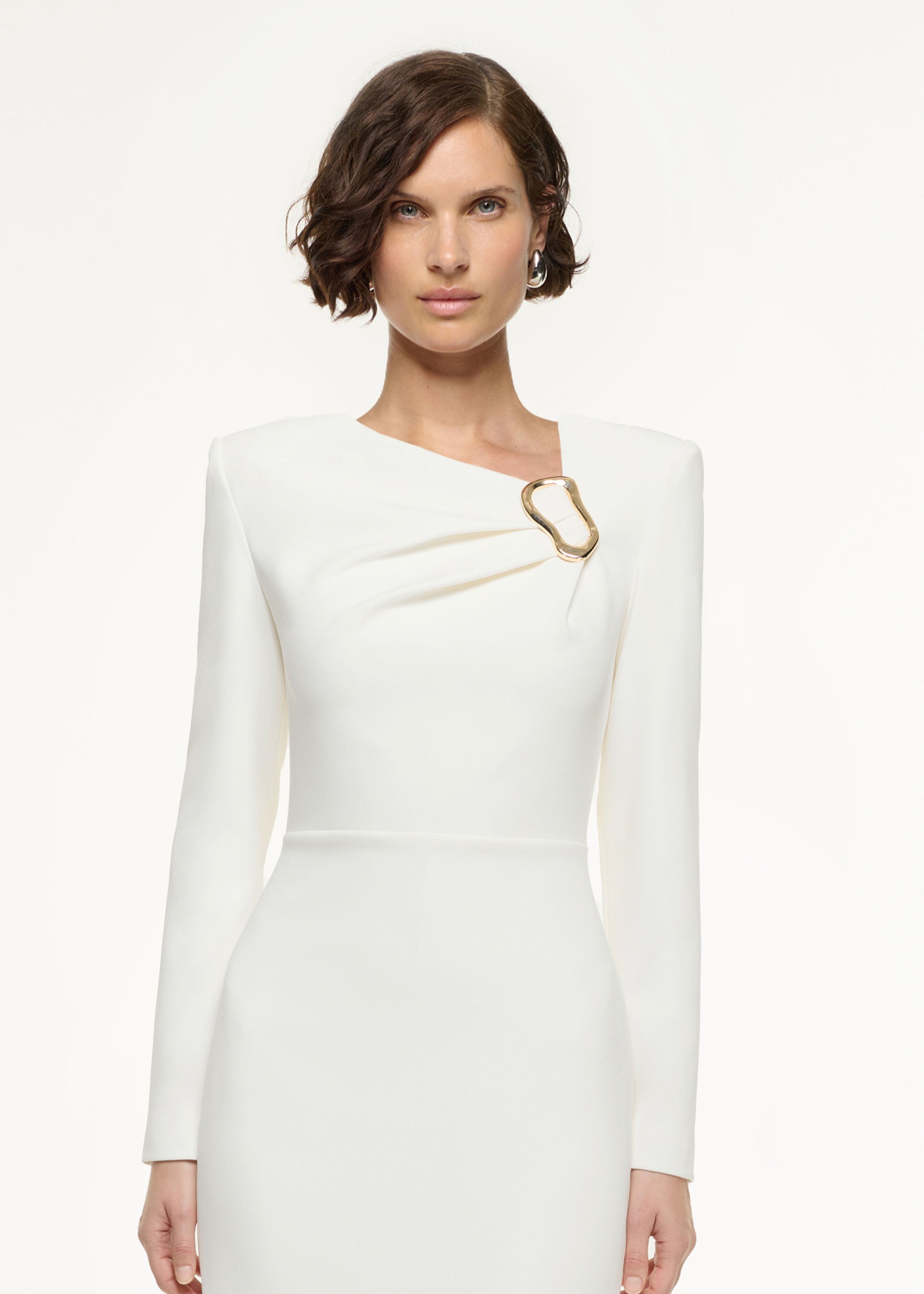 Close up of a model wearing the Long Sleeve Buckle Crepe Midi Dress in Cream