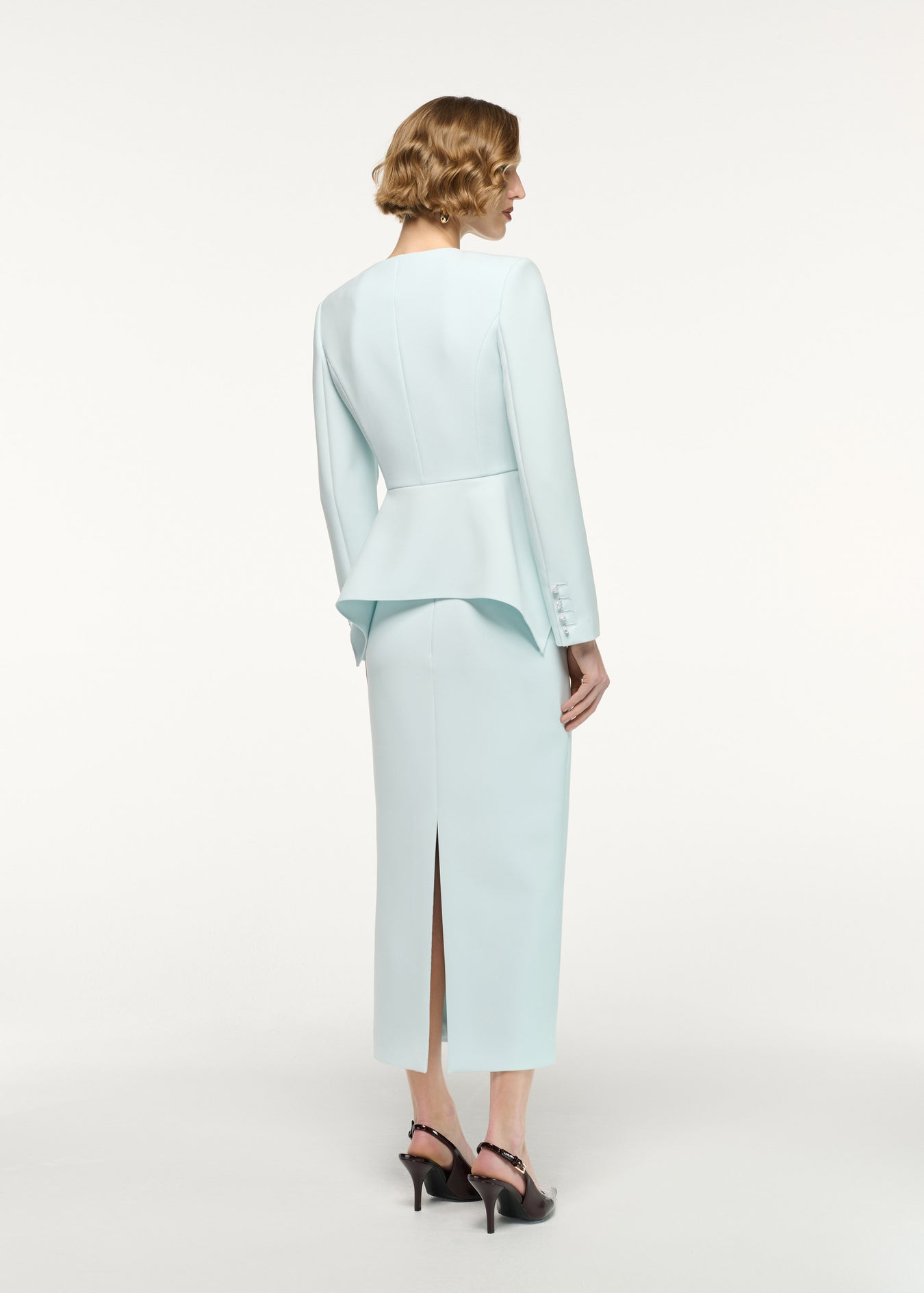 Back view of a model wearing the Crepe Midi Skirt in Aqua 