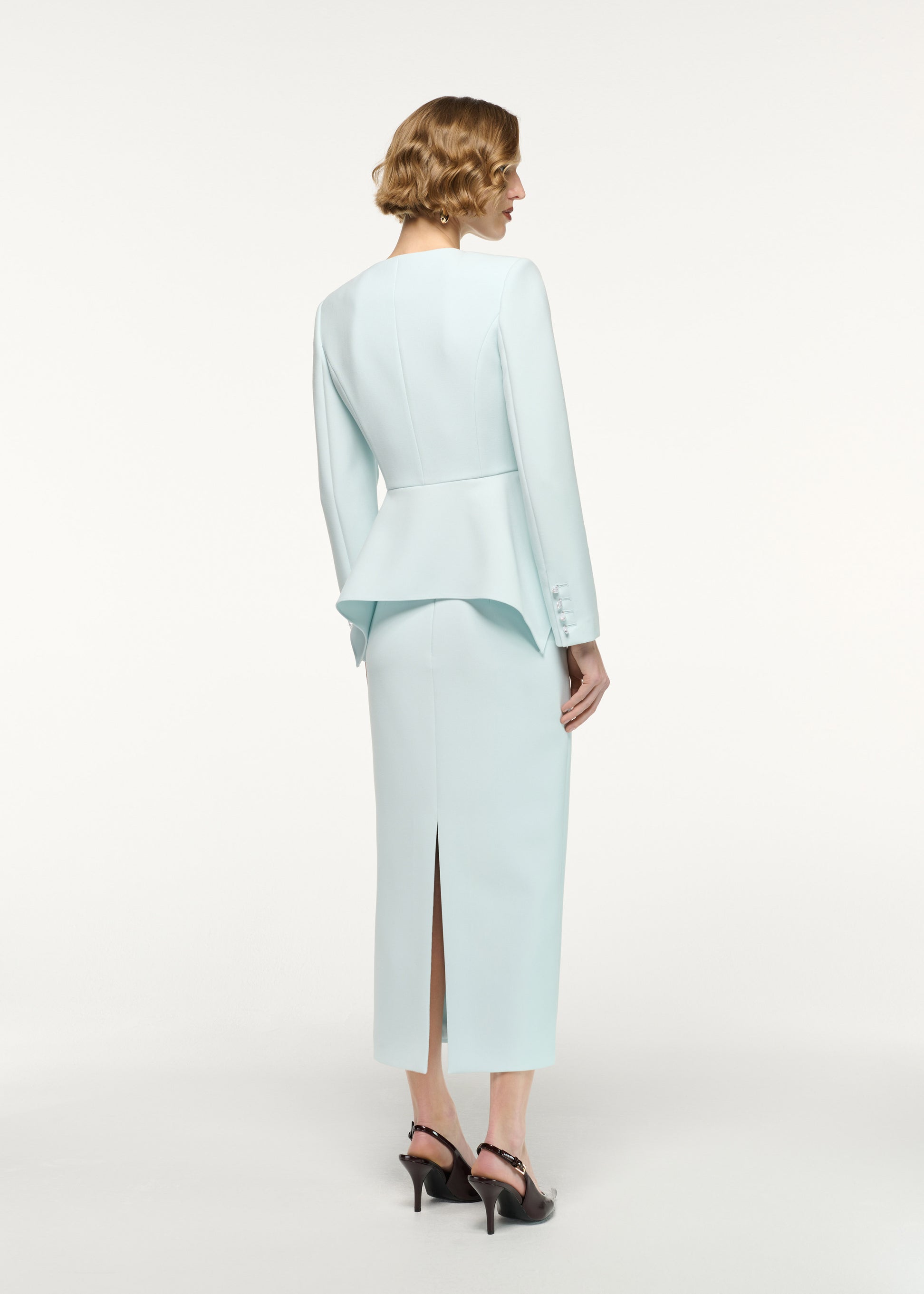 Back view of a model wearing the Crepe Midi Skirt in Aqua 