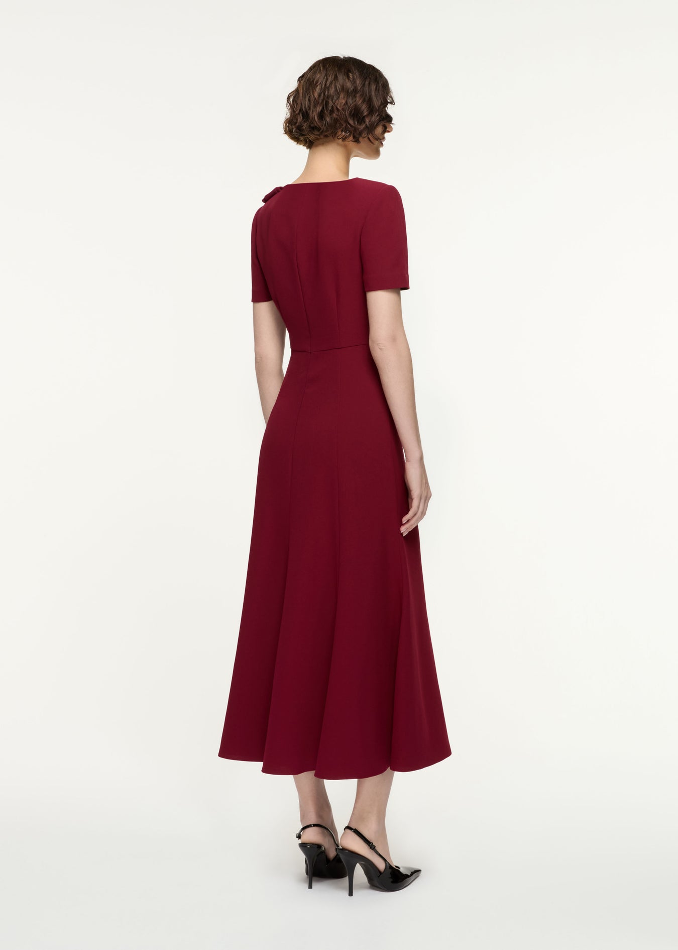 Back view of a model wearing the Short Sleeve Heavy Cady Midi Dress in Red