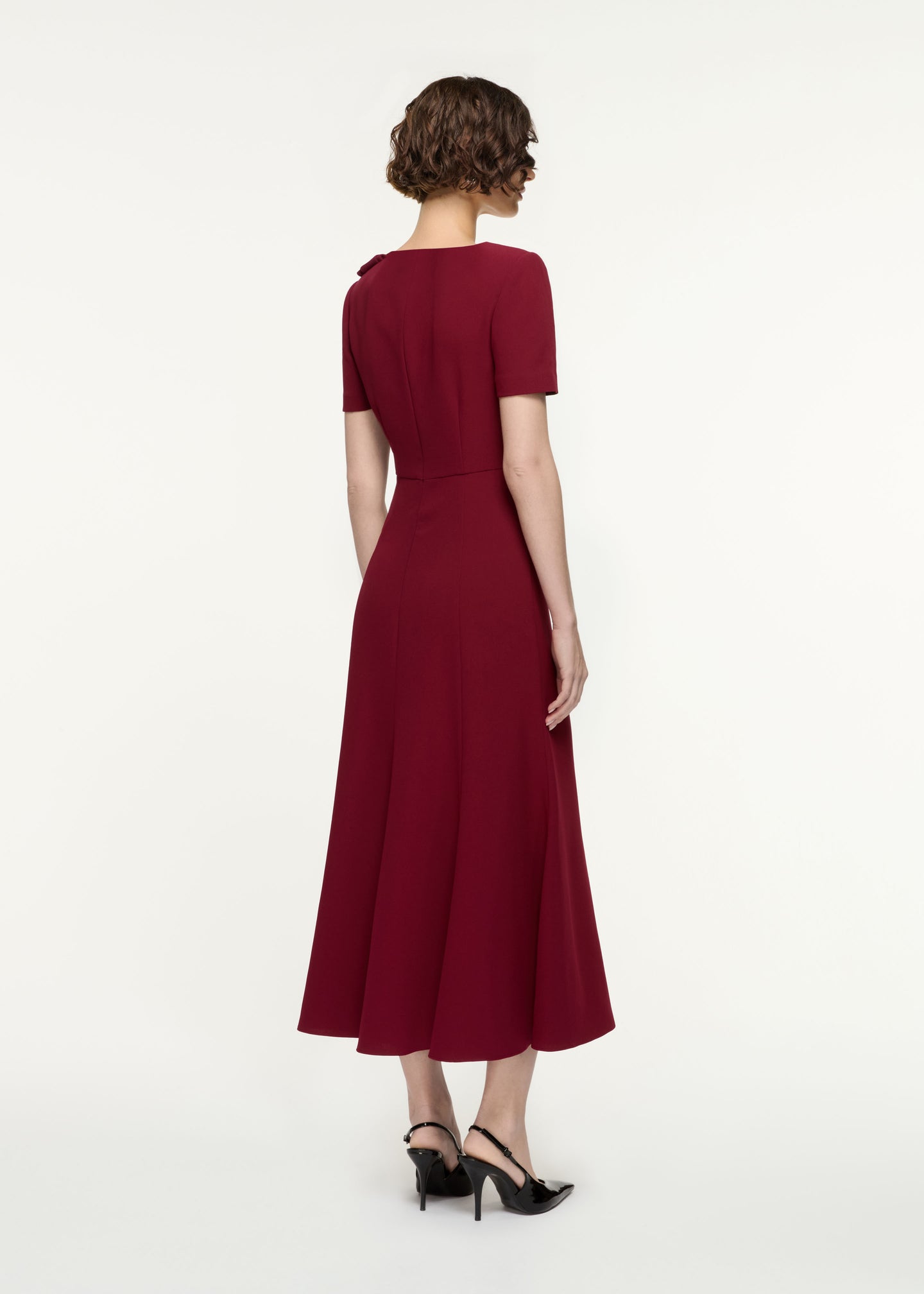 Back view of a model wearing the Short Sleeve Heavy Cady Midi Dress in Red