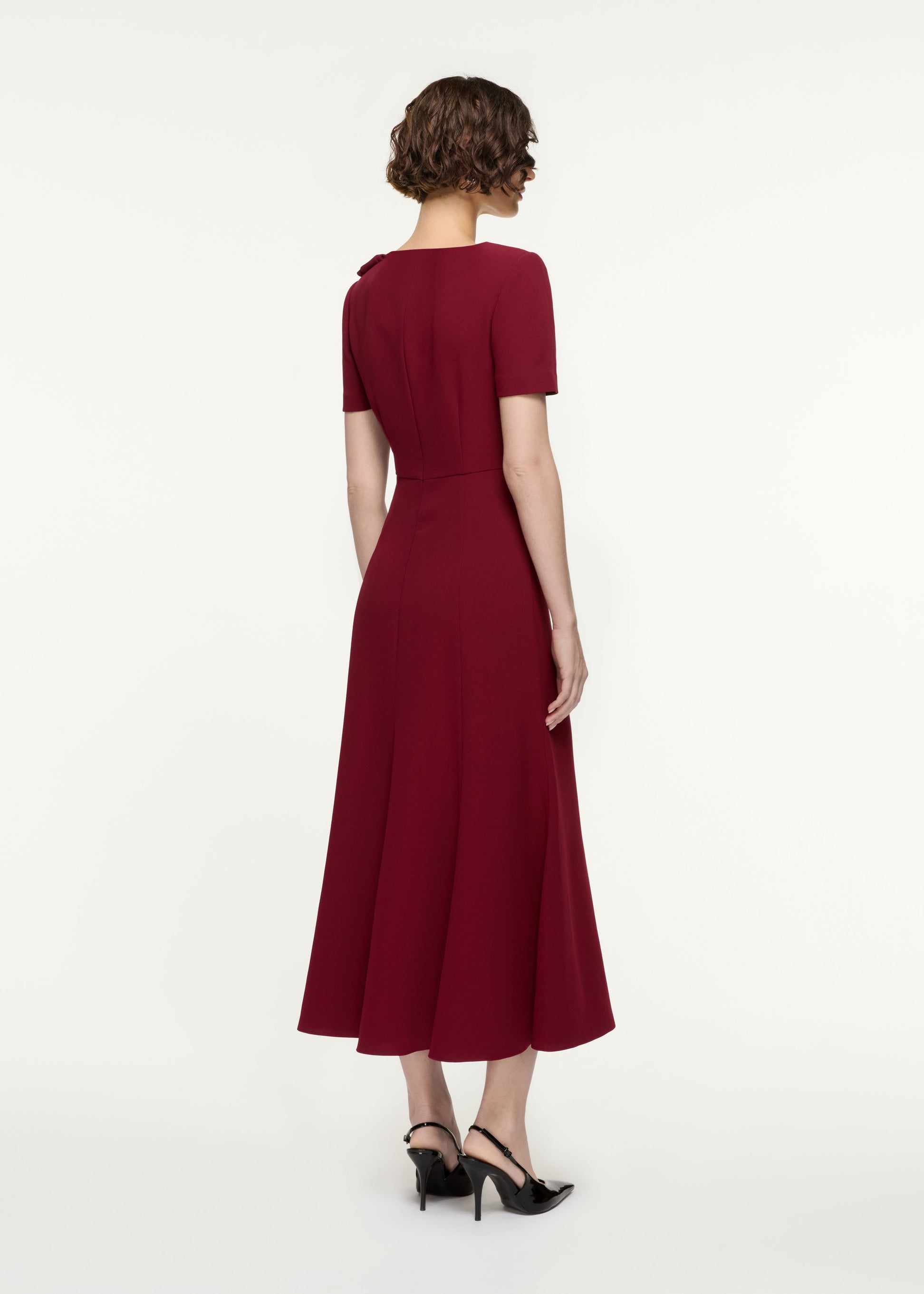 Back view of a model wearing the Short Sleeve Heavy Cady Midi Dress in Red