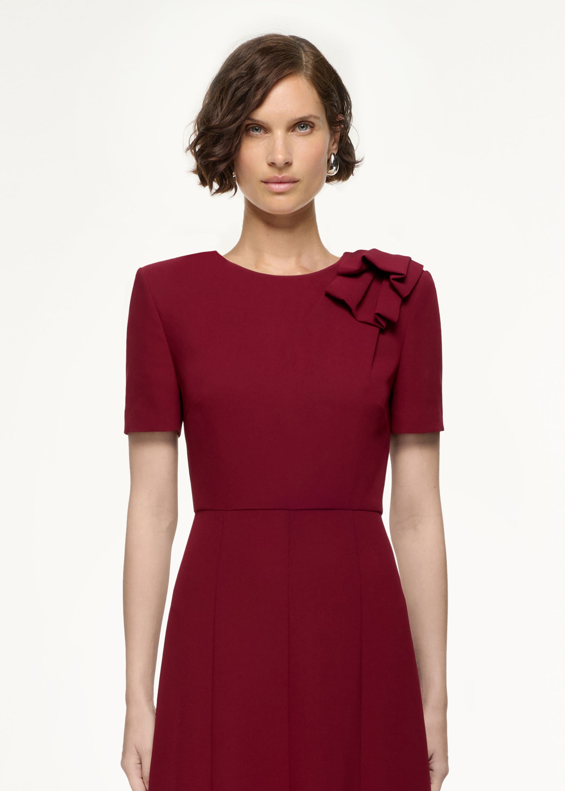 Close up of a model wearing the Short Sleeve Heavy Cady Midi Dress in Red