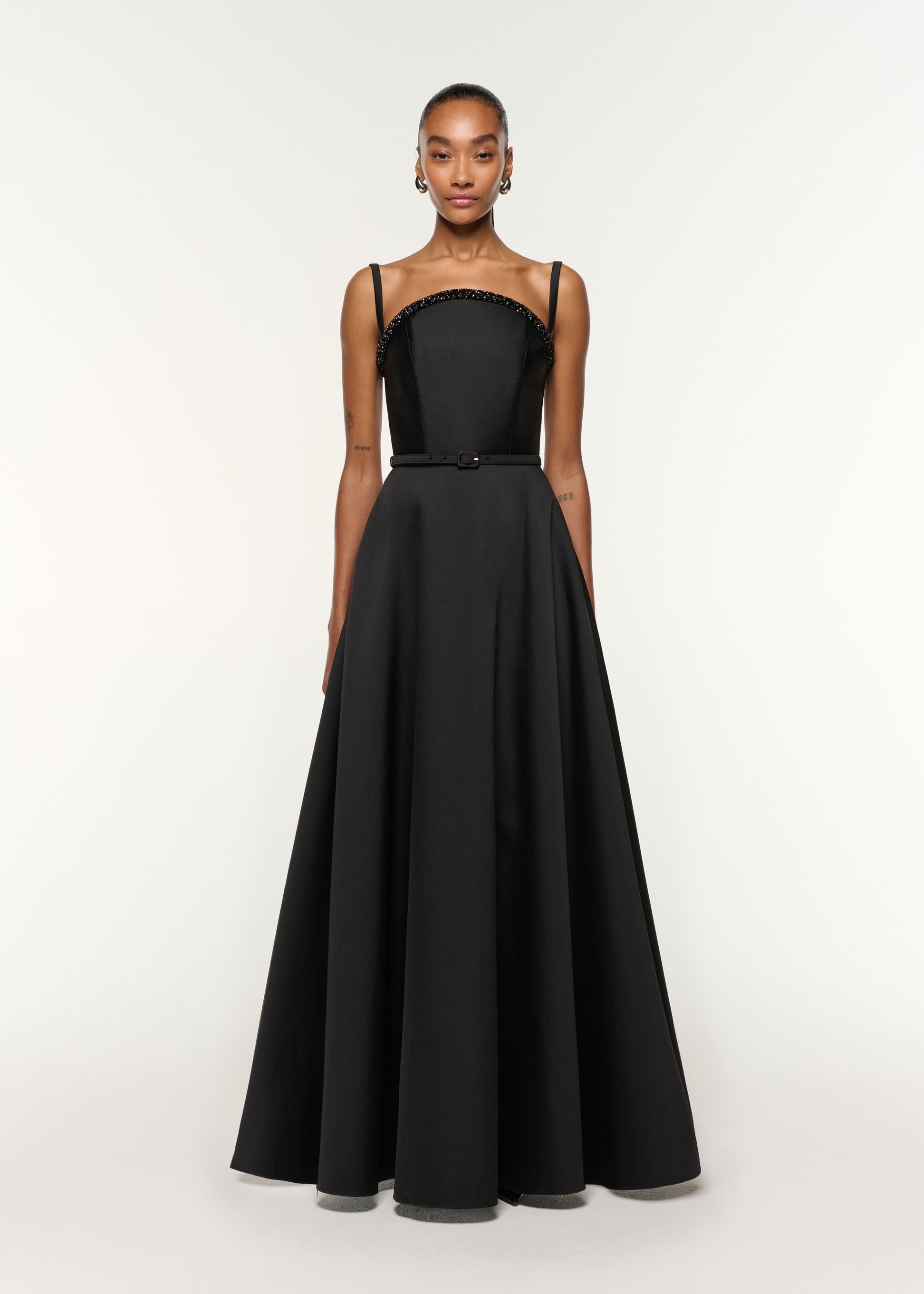 Front view of a model wearing the Curved Crystal Neckline Taffeta Gown in Black
