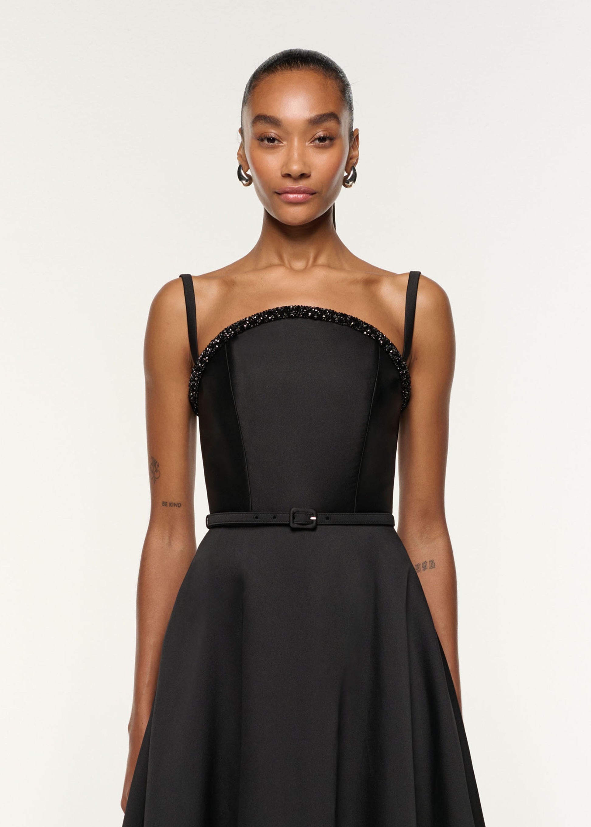 Close up of a model wearing the Curved Crystal Neckline Taffeta Gown in Black