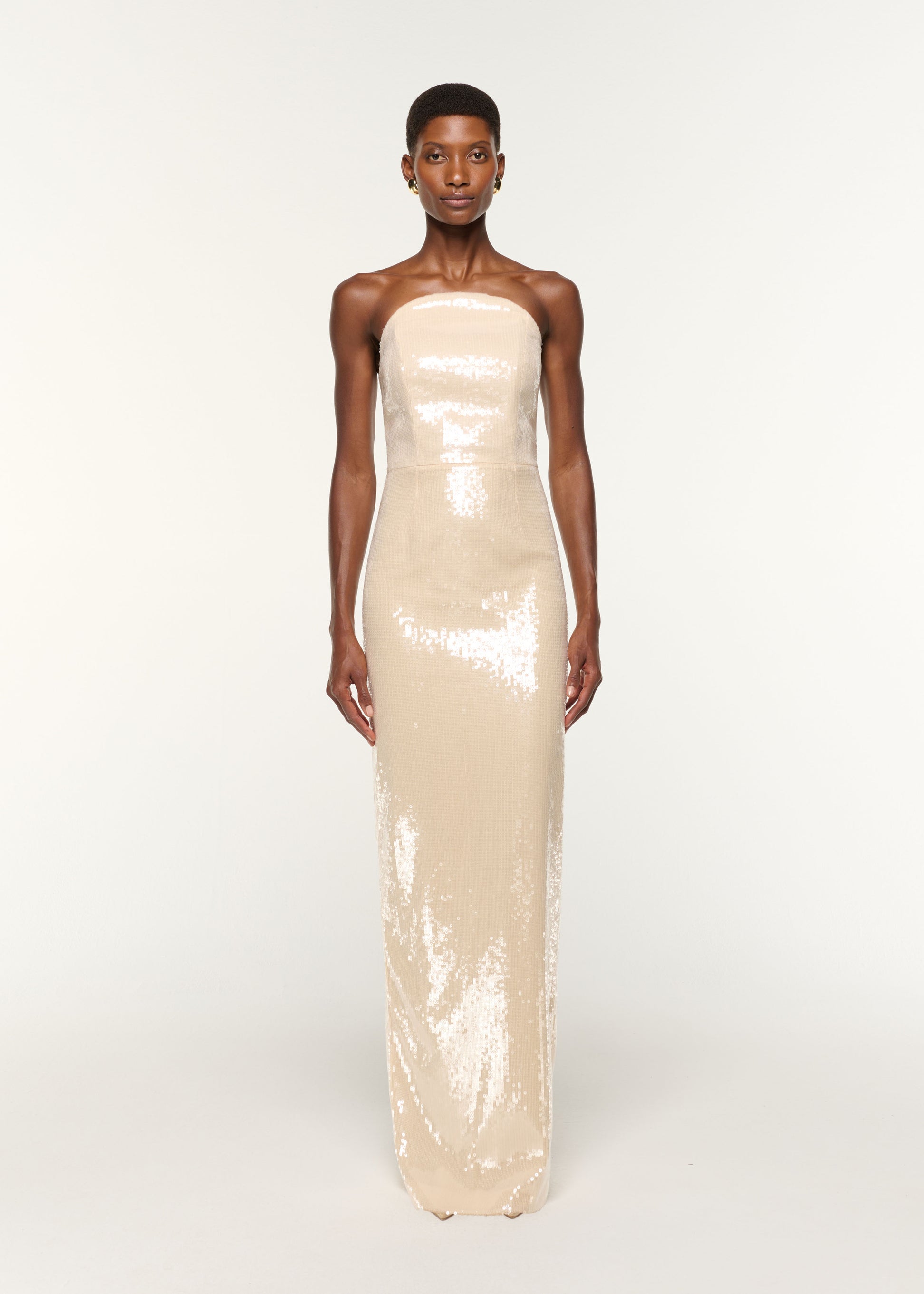 Front view of a model wearing the Curved Neckline Sequin Column Gown in Cream